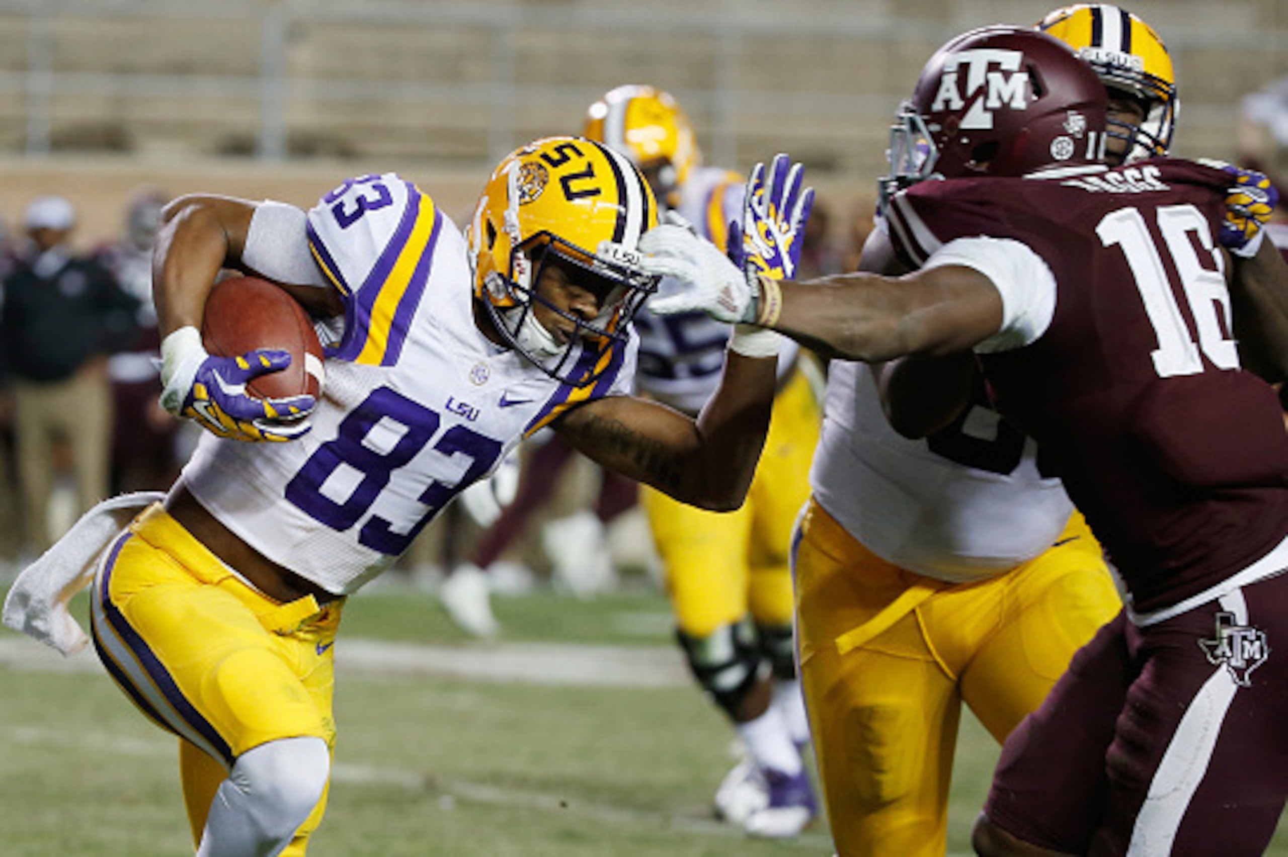 COLLEGE STATION, TX - NOVEMBER 27:  Travin Dural #83 of the LSU Tigers runs away from Donnie Baggs #16 of the Texas A&M Aggies in the second half of their game at Kyle Field on November 27, 2014 in College Station, Texas.  (Photo by Scott Halleran/Getty I