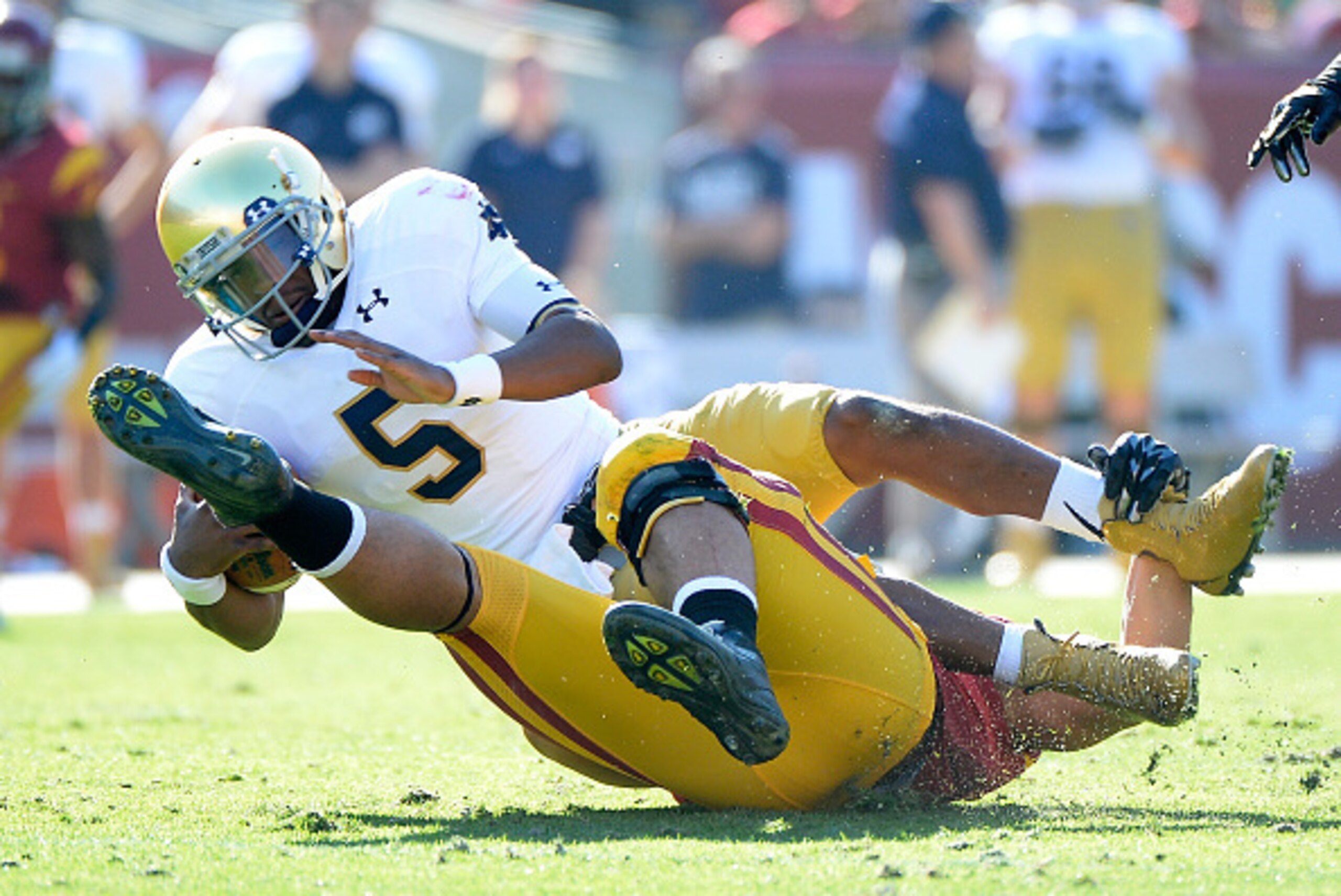 LOS ANGELES, CA - NOVEMBER 29:  Everett Golson #5 of the Notre Dame Fighting Irish is sacked by J.R. Tavai #58 of the USC Trojans during the second quarter at Los Angeles Memorial Coliseum on November 29, 2014 in Los Angeles, California.  (Photo by Harry 