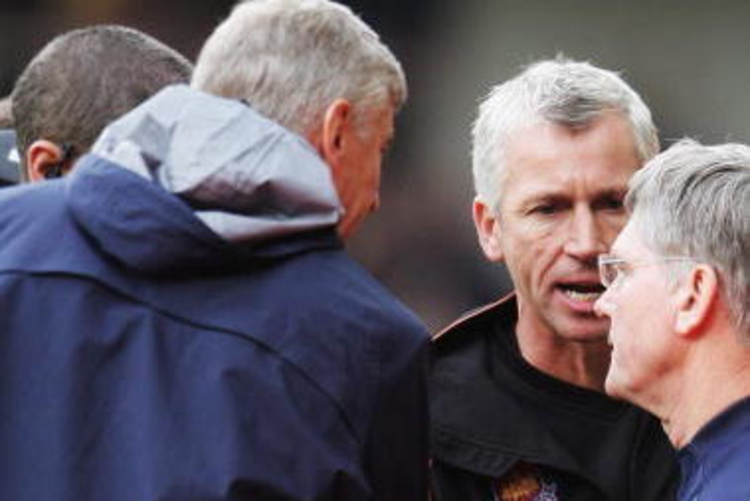 LONDON - NOVEMBER 05:  Alan Pardew (C) the West Ham United manager tries to shake hands with Arsene Wenger (L) the Arsenal manager and Pat Rice (R) the Arsenal assistant manager during the Barclays Premiership match between West Ham United and Arsenal at 