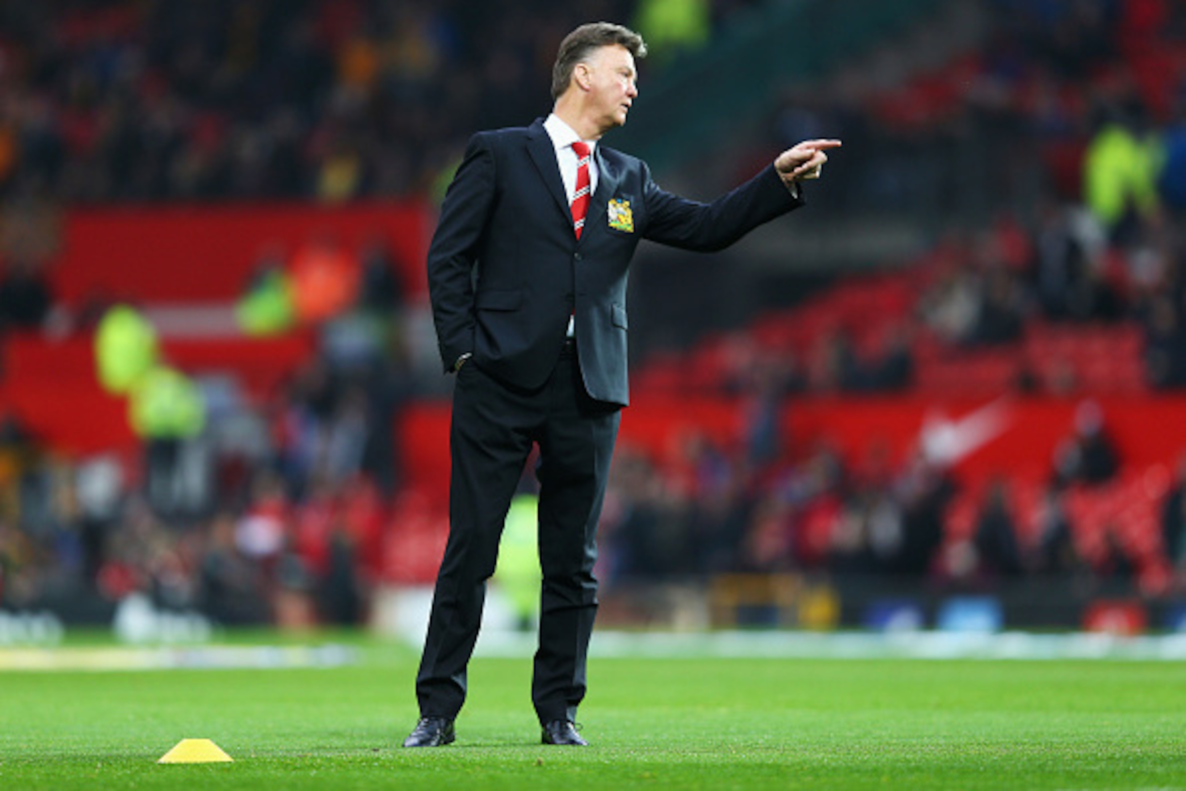 MANCHESTER, ENGLAND - NOVEMBER 29: Louis van Gaal manager of Manchester United signals prior to the Barclays Premier League match between Manchester United and Hull City at Old Trafford on November 29, 2014 in Manchester, England. (Photo by Clive Mason/ MANCHESTER, ENGLAND - NOVEMBER 29: Louis van Gaal manager of Manchester United signals prior to the Barclays Premier League match between Manchester United and Hull City at Old Trafford on November 29, 2014 in Manchester, England. (Photo by Clive Mason/
