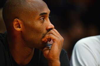 LOS ANGELES, CA - DECEMBER 09:  Kobe Bryant #24 of the Los Angeles Lakers watches from the bench during a game against the Sacramento Kings at Staples Center on December 9, 2014 in Los Angeles, California.   NOTE TO USER: User expressly acknowledges and a