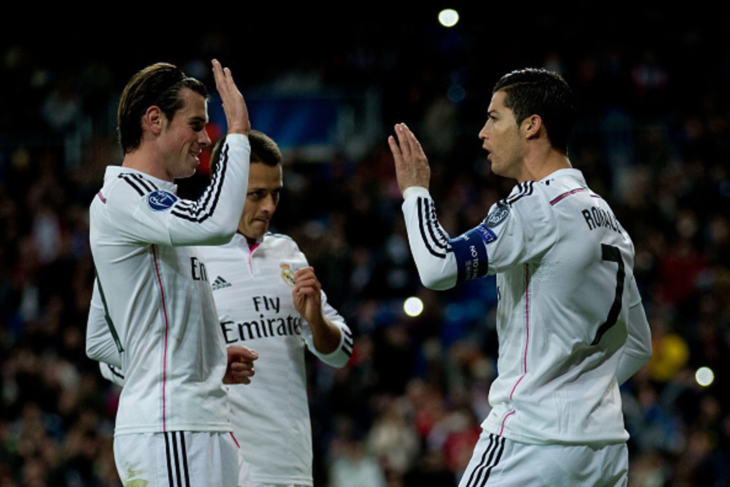 MADRID, SPAIN - DECEMBER 09:  Cristiano Ronaldo (R) of Real Madrid CF celebrates scoring their opening goal with teammates Gareth Bale (L) and Javier Hernandez Chicharito (2ndL) during the UEFA Champions League Group B match between Real Madrid CF and PFC