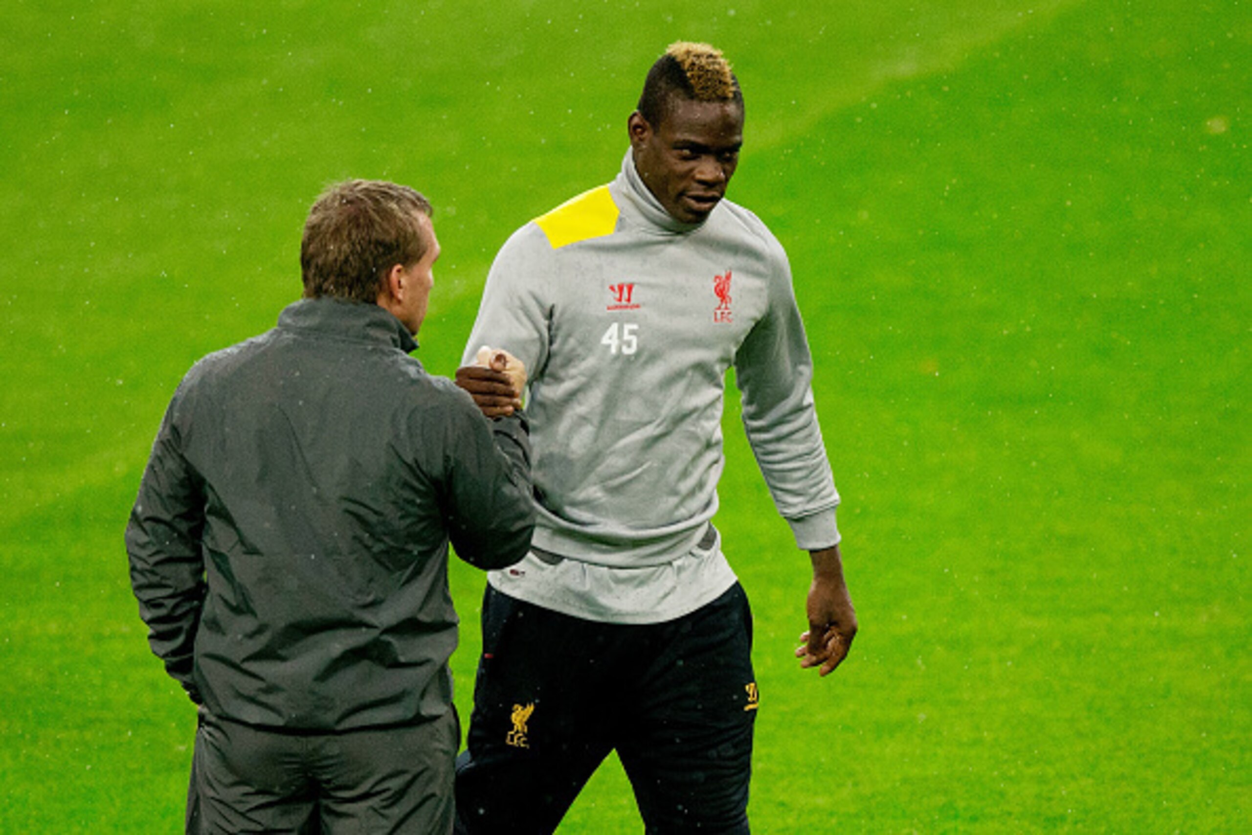 MADRID, SPAIN - NOVEMBER 03: Head coach Brendan Rodgers (L) of Liverpool FC shakes hands with his player Mario Balotelli (R) during the training session ahead of the UEFA Champions League Group B match between Real Madrid CF and Liverpool FC at Estadio Sa