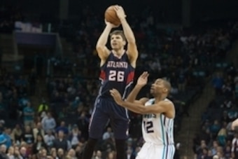 Nov 7, 2014; Charlotte, NC, USA; Atlanta Hawks guard Kyle Korver (26) shoots the ball over Charlotte Hornets guard Gary Neal (12) during the second half at Time Warner Cable Arena. Charlotte defeated Atlanta 122-119 in double overtime. Mandatory Credit: J