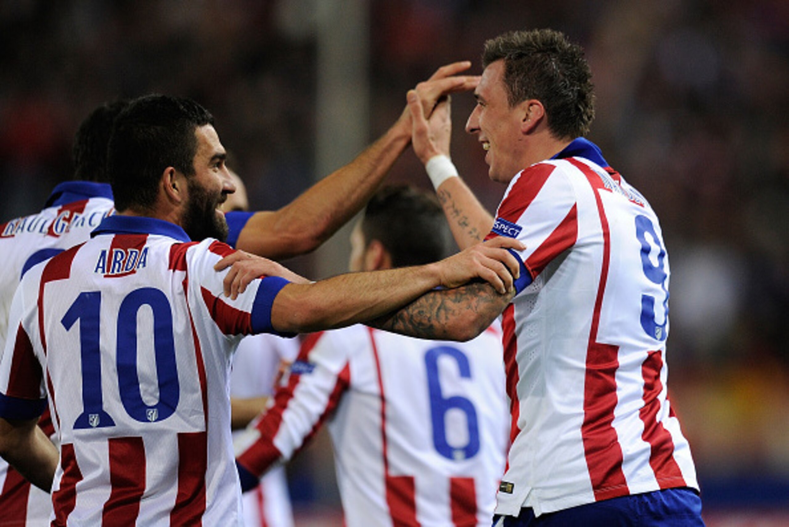 MADRID, SPAIN - NOVEMBER 26:  Mario Mandzukic of Club Atletico de Madrid  celebrates with Arda Turan after scoring his team's 4th goal during the UEFA Champions League Group A match between Club Atletico de Madrid and Olympiacos FC at Vicente Calderon Sta
