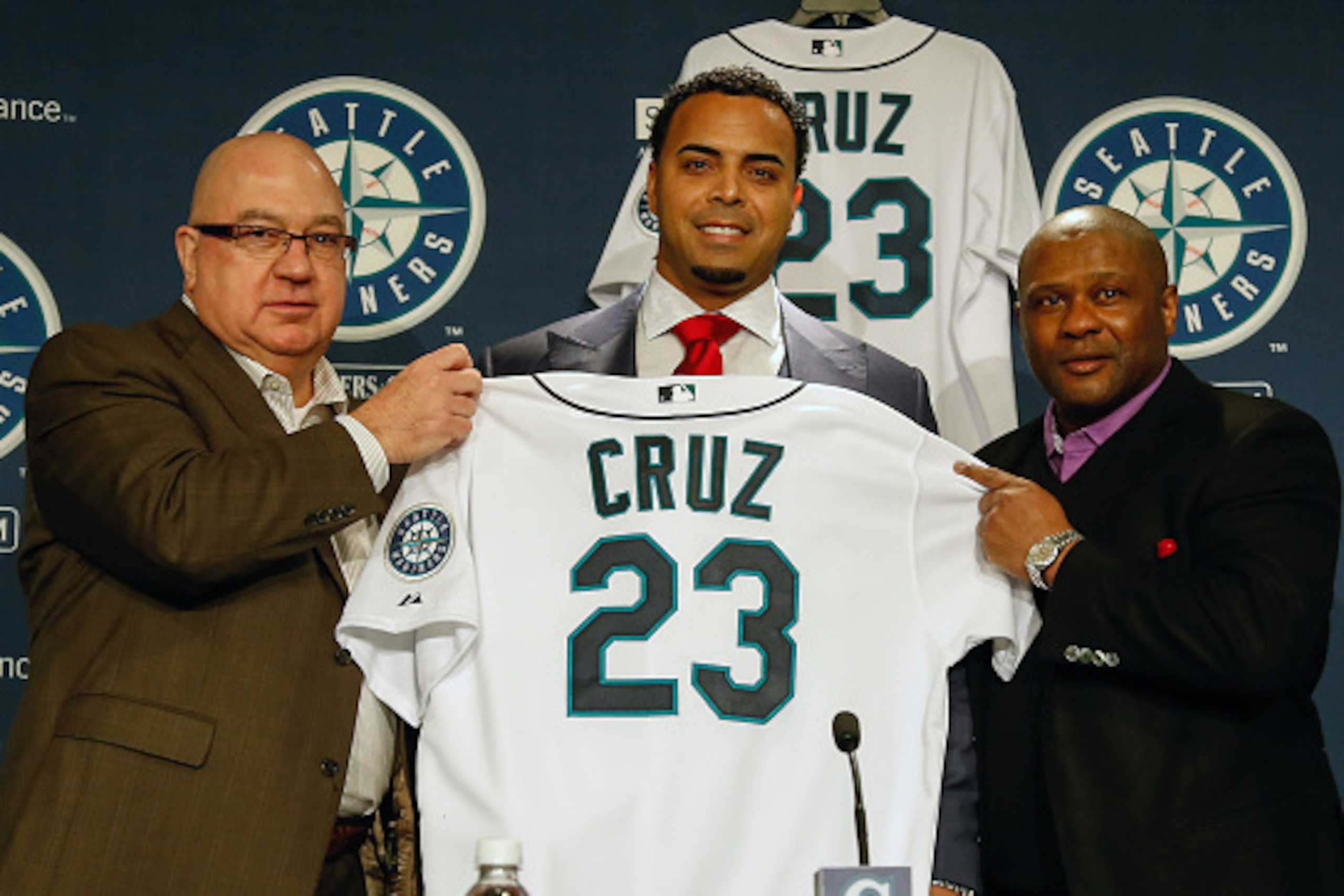SEATTLE, WA - DECEMBER 04:  L to R: GM Jack Zduriencik, Nelson Cruz, and manager Lloyd McClendon of the Seattle Mariners pose for a photo as Cruz is introduced to the media during a press conference at Safeco Field on December 4, 2014 in Seattle, Washingt