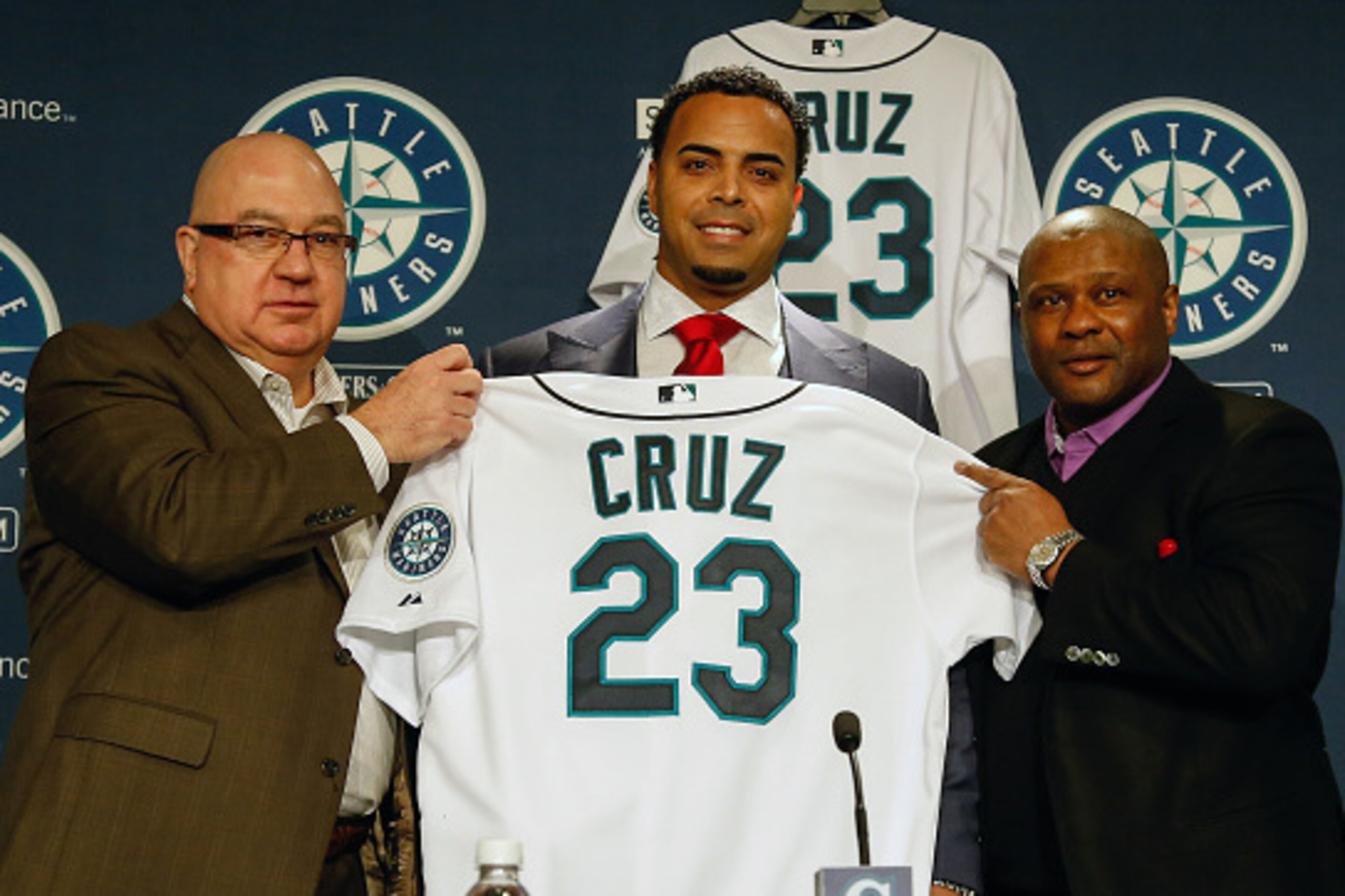 SEATTLE, WA - DECEMBER 04:  L to R: GM Jack Zduriencik, Nelson Cruz, and manager Lloyd McClendon of the Seattle Mariners pose for a photo as Cruz is introduced to the media during a press conference at Safeco Field on December 4, 2014 in Seattle, Washingt