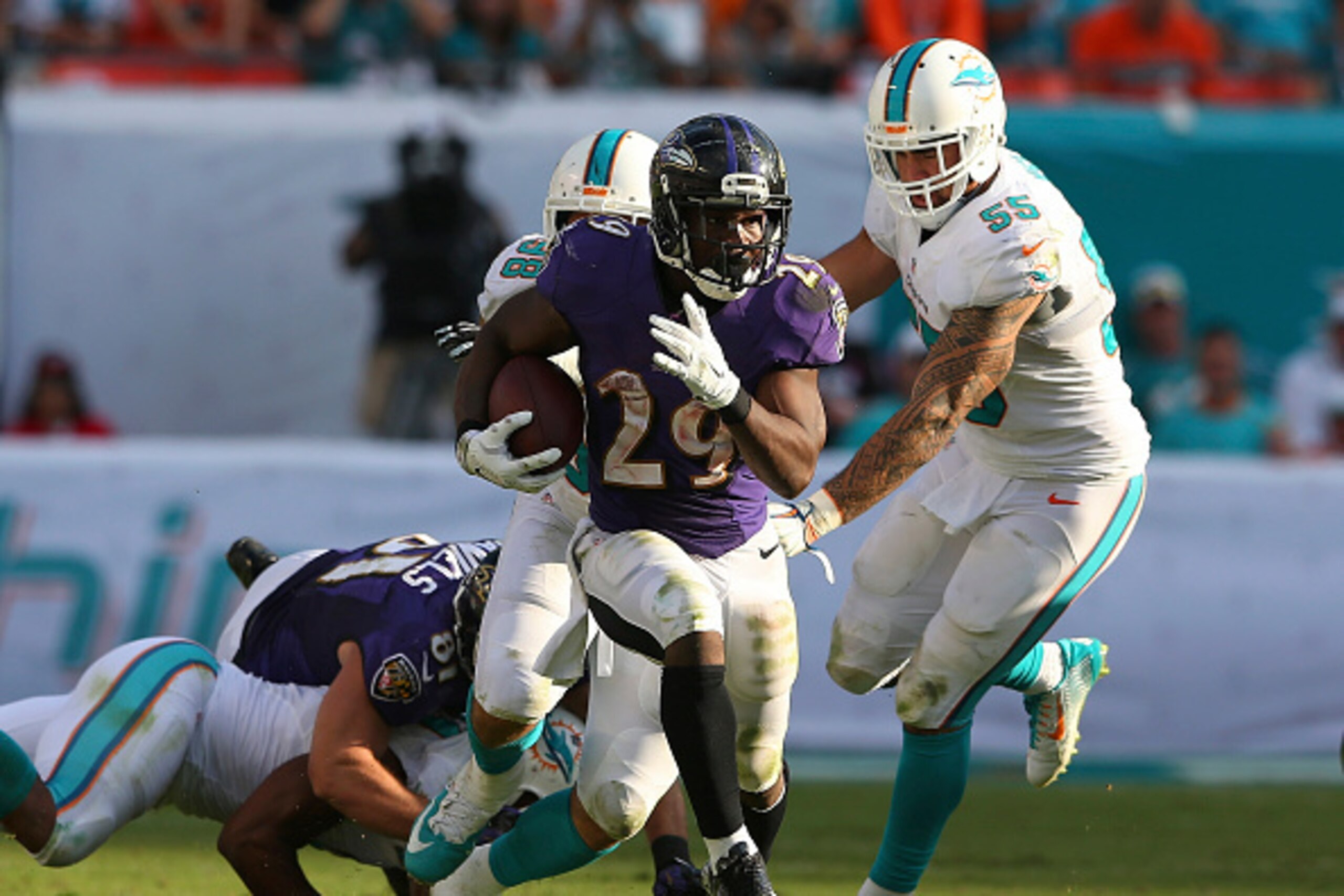 MIAMI GARDENS, FL - DECEMBER 07:  Running back Justin Forsett #29 of the Baltimore Ravens runs for fourth quarter yardage against the Miami Dolphins during a game at Sun Life Stadium on December 7, 2014 in Miami Gardens, Florida. The Ravens defeated the D