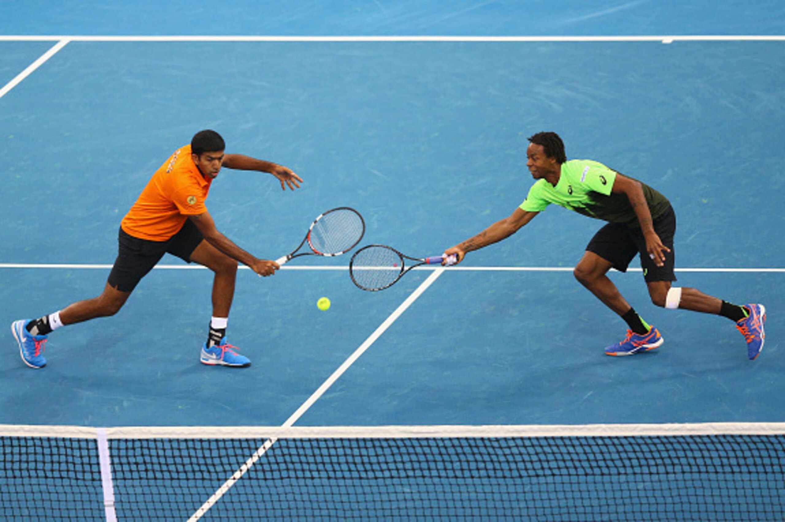 DUBAI, UNITED ARAB EMIRATES -DECEMBER12: Gael Monfils and Rohan Bopanna of the Indian Aces in action against Jo-Wilfried Tsonga and Daniel Nestor of the Manila Mavericks during the Coca-Cola International Premier Tennis League fourth leg at the Hamdan Spo