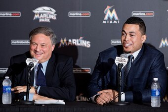 MIAMI, FL - NOVEMBER 19:  Giancarlo Stanton of the Miami Marlins speaks as owner Jeffrey Loria looks on during a press conference at Marlins Park on November 19, 2014 in Miami, Florida.  (Photo by Rob Foldy/Getty Images)
