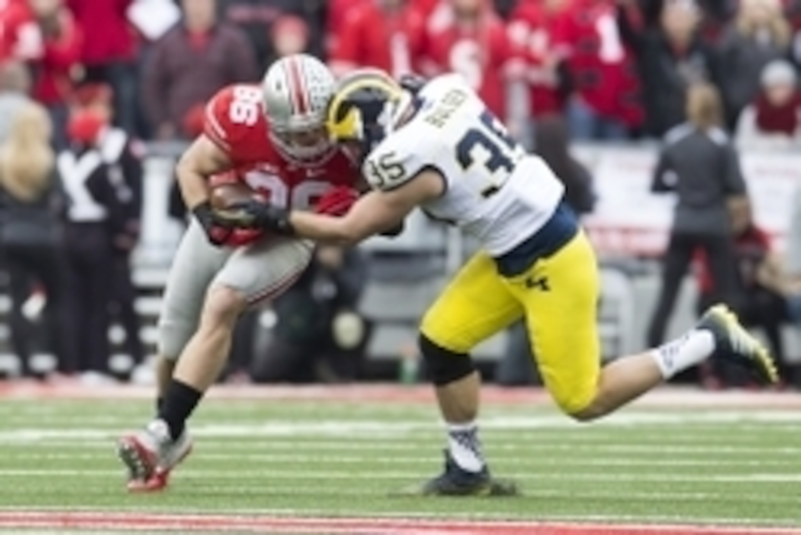 Nov 29, 2014; Columbus, OH, USA; Ohio State Buckeyes tight end Jeff Heuerman (86) is hit by Michigan Wolverines linebacker Joe Bolden (35) at Ohio Stadium. Mandatory Credit: Greg Bartram-USA TODAY Sports Nov 29, 2014; Columbus, OH, USA; Ohio State Buckeyes tight end Jeff Heuerman (86) is hit by Michigan Wolverines linebacker Joe Bolden (35) at Ohio Stadium. Mandatory Credit: Greg Bartram-USA TODAY Sports