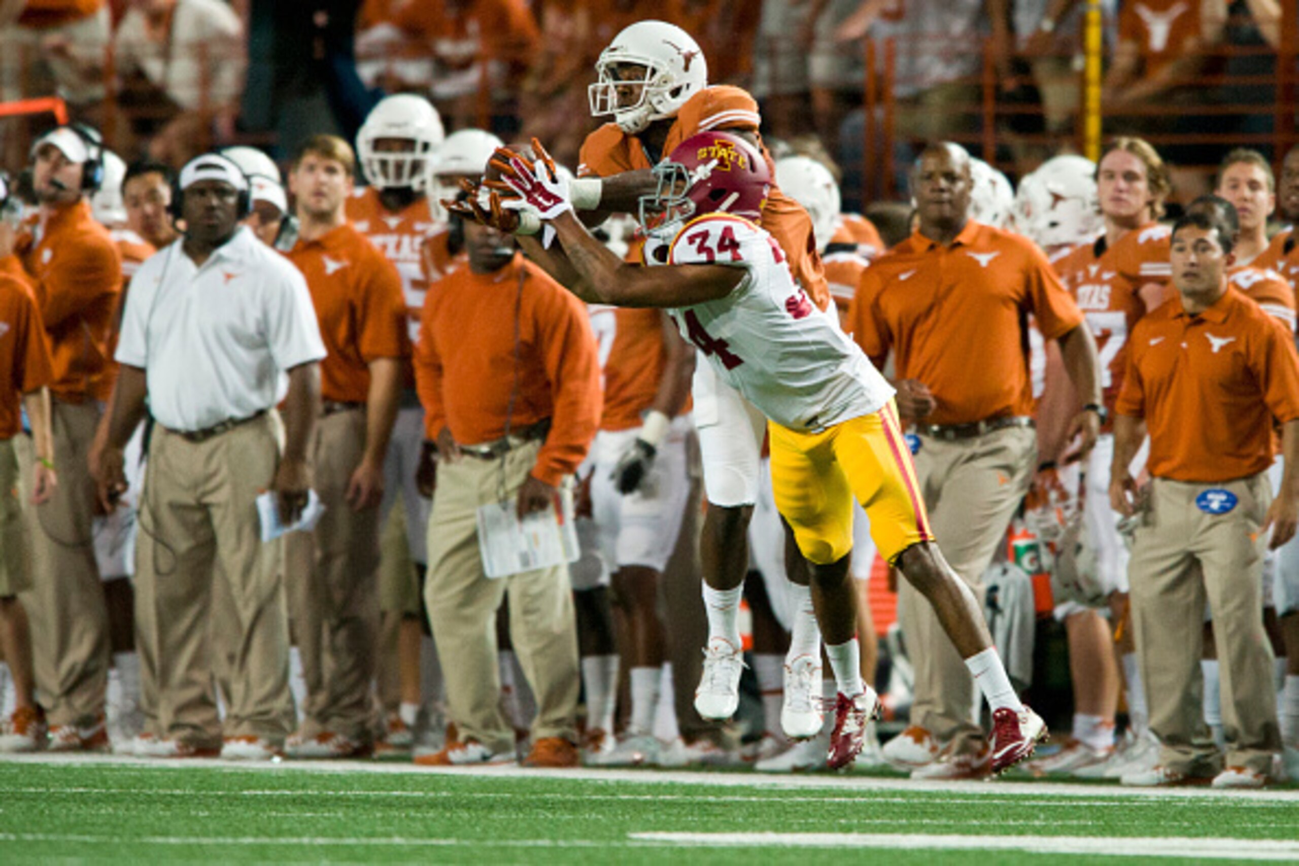 AUSTIN, TX - OCTOBER 18:  John Harris #9 of the Texas Longhorns makes a catch over Nigel Tribune #34 of the Iowa State Cyclones on October 18, 2014 at Darrell K Royal-Texas Memorial Stadium in Austin, Texas.  (Photo by Cooper Neill/Getty Images)