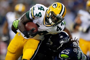 SEATTLE, WA - SEPTEMBER 04: Running back James Starks #44 of the Green Bay Packers is hit by cornerback Richard Sherman #25 of the Seattle Seahawks during the third quarter of the game at CenturyLink Field on September 4, 2014 in Seattle, Washington.  (Ph