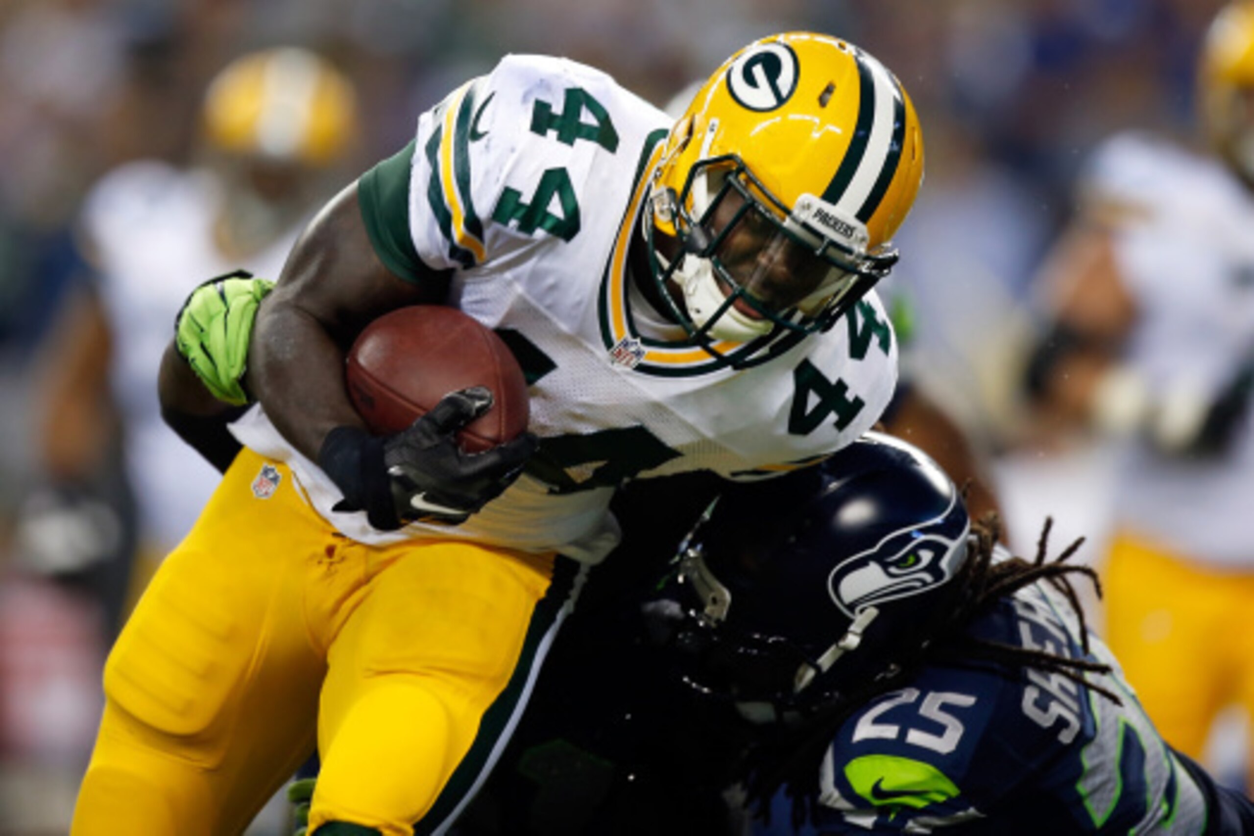 SEATTLE, WA - SEPTEMBER 04: Running back James Starks #44 of the Green Bay Packers is hit by cornerback Richard Sherman #25 of the Seattle Seahawks during the third quarter of the game at CenturyLink Field on September 4, 2014 in Seattle, Washington.  (Ph