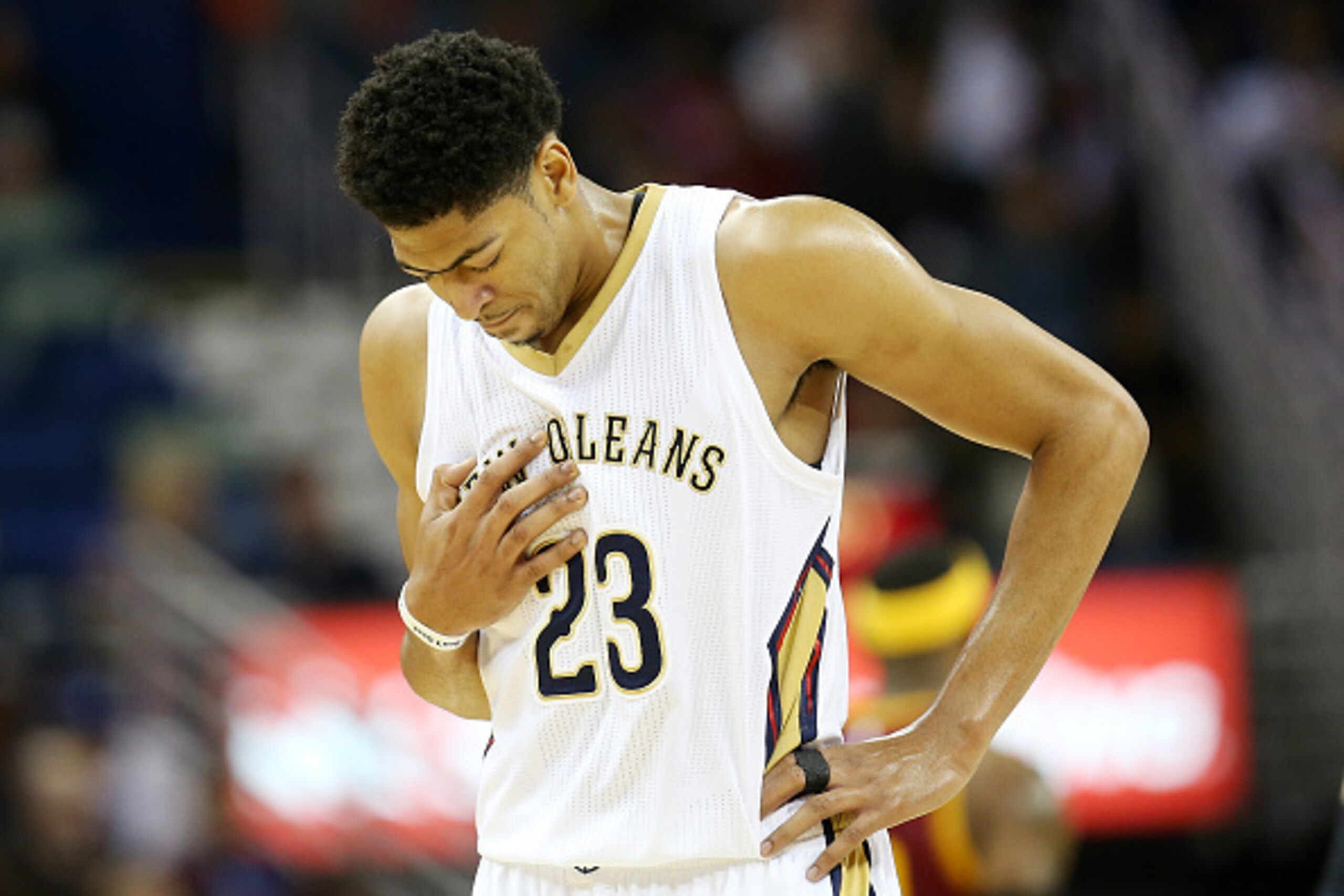 NEW ORLEANS, LA - DECEMBER 12:  Anthony Davis #23 of the New Orleans Pelicans walks off the court holding his chest while playing the Cleveland Cavaliers at Smoothie King Center on December 12, 2014 in New Orleans, Louisiana.  NOTE TO USER: User expressly