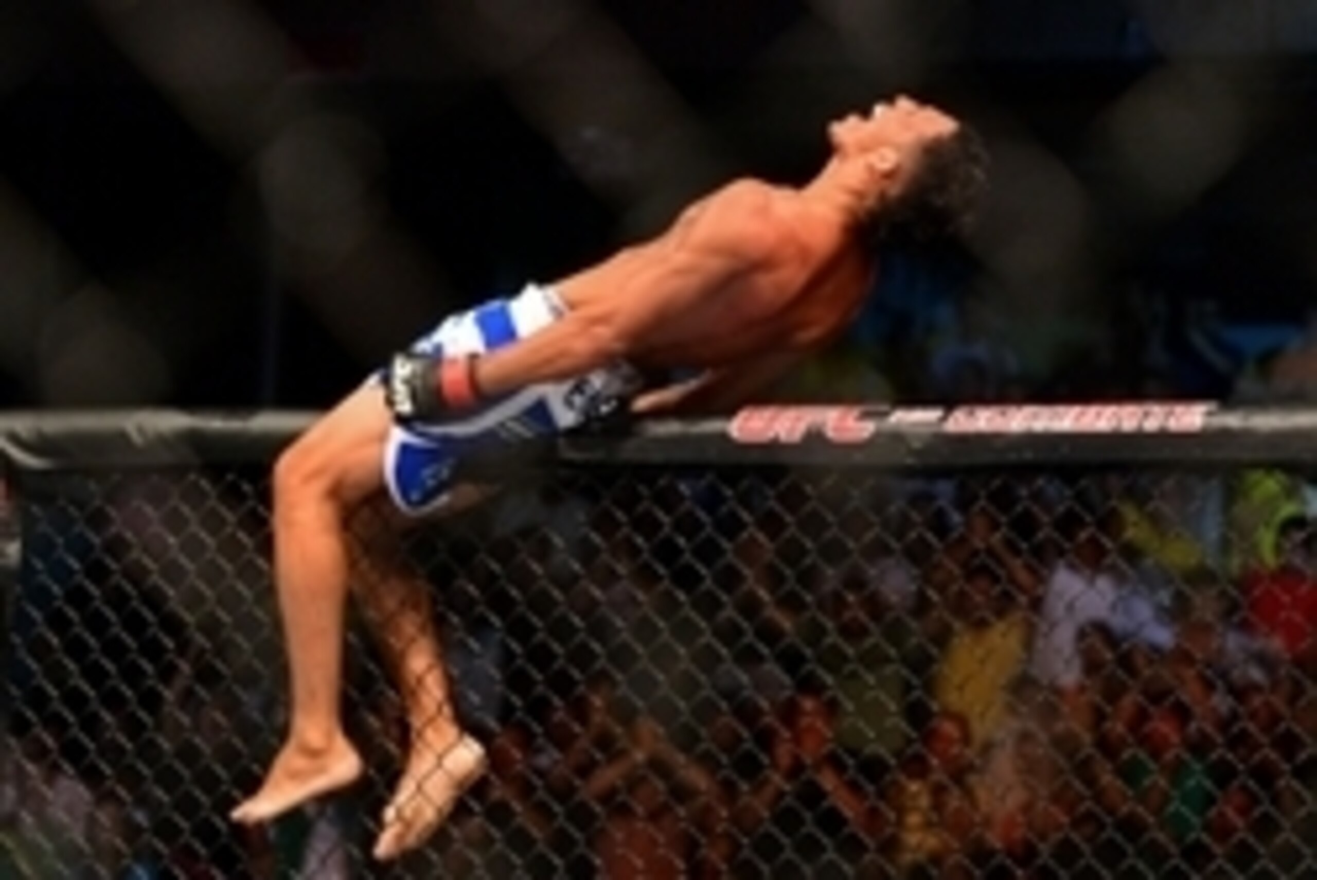 Feb 15, 2014; Jaragua do Sul, SC, Brazil; Charles Oliveira (red gloves) reacts after defeating Andy Ogle (blue gloves) during UFC Fight Night Machida vs Mousasi at Arena Jaragua. Mandatory Credit: Jason Silva-USA TODAY Sports