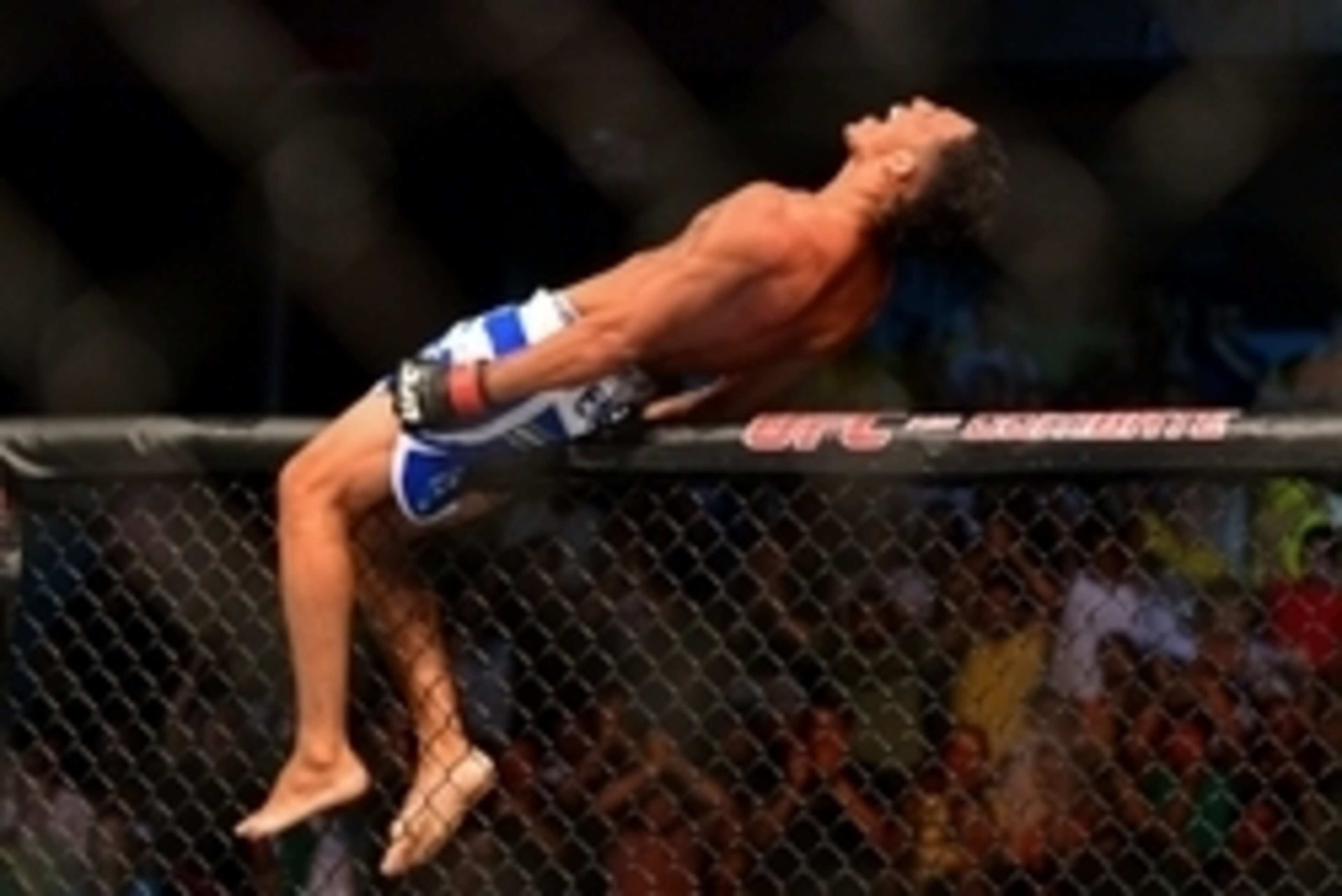 Feb 15, 2014; Jaragua do Sul, SC, Brazil; Charles Oliveira (red gloves) reacts after defeating Andy Ogle (blue gloves) during UFC Fight Night Machida vs Mousasi at Arena Jaragua. Mandatory Credit: Jason Silva-USA TODAY Sports