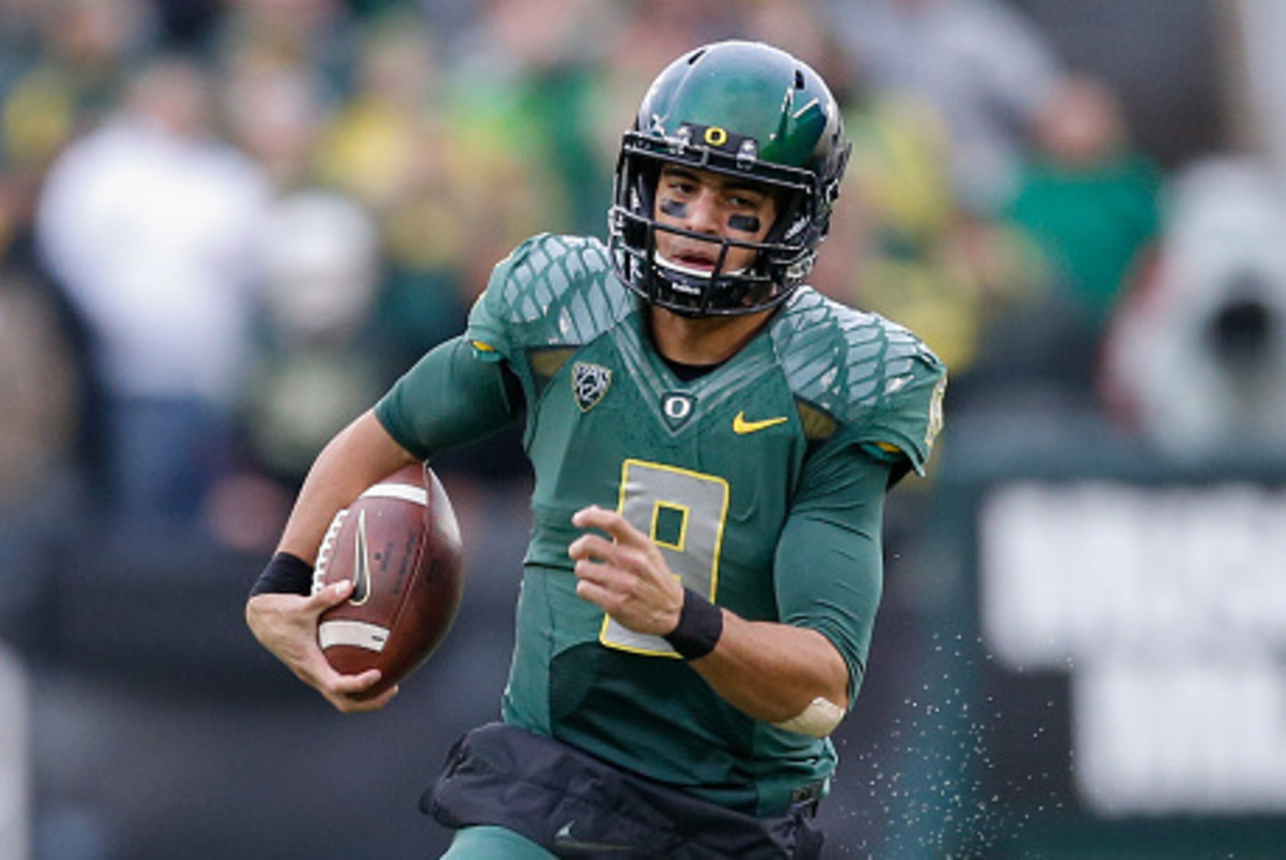 EUGENE, OR - NOVEMBER 22:  Quarterback Marcus Mariota #8 of the Oregon Ducks rushes for a touchdown in the first quarter against the Colorado Buffaloes at Autzen Stadium on November 22, 2014 in Eugene, Oregon. The Ducks defeated the Buffaloes 44-10.  (Pho