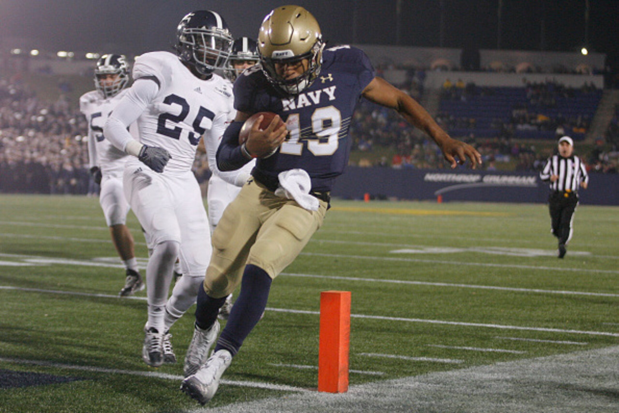 ANNAPOLIS, MD - NOVEMBER 15: Keenan Reynolds #19 of the Navy Midshipmen scores a touchdown as he is chased by Robert Brice #25 of the Georgia Southern Eagles during the second half at the Navy-Marines Memorial Stadium on November 15, 2014 in Annapolis, Ma