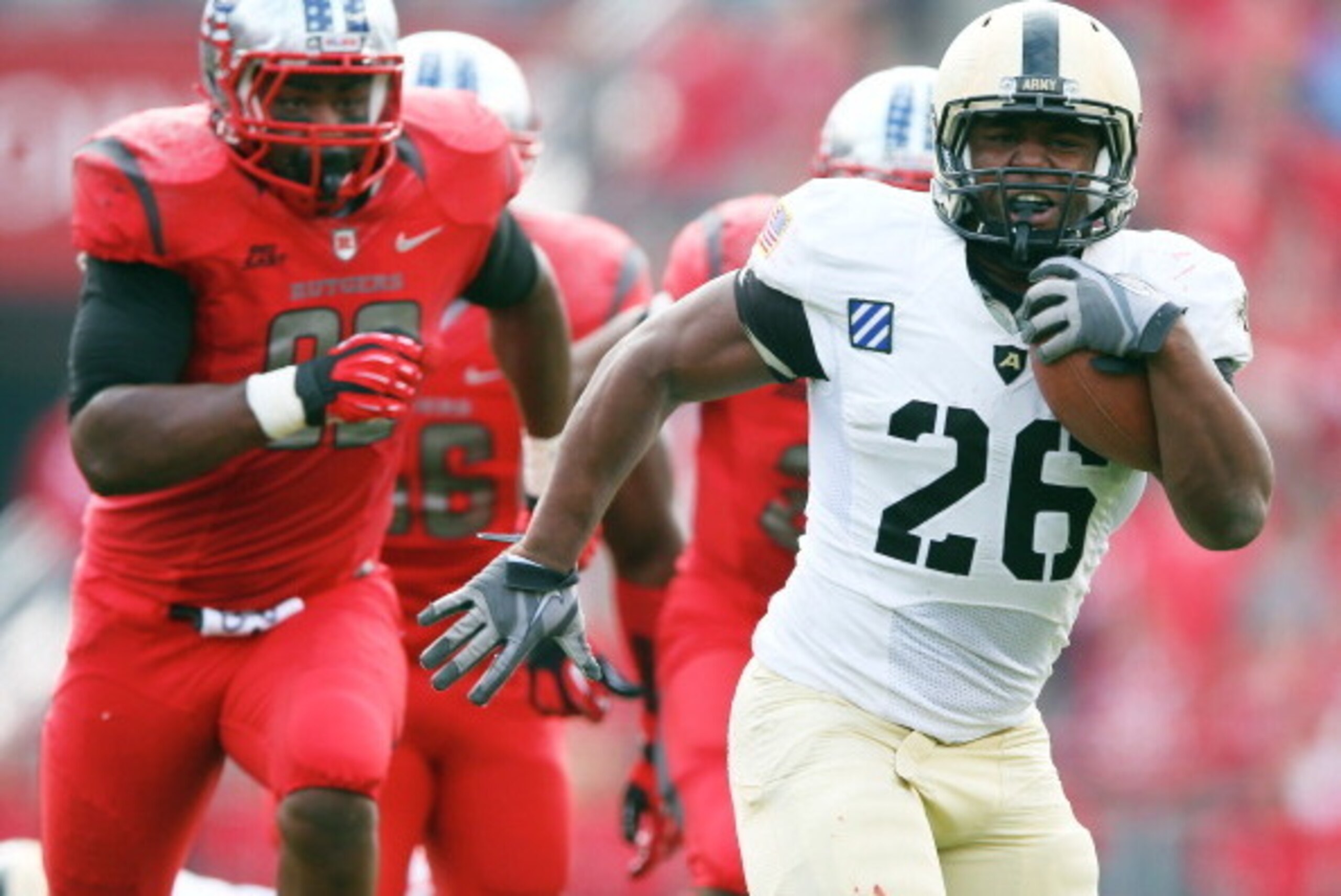 PISCATAWAY, NJ - NOVEMBER 10:  Larry Dixon #26 of the Army Black Knights carries the ball in the first quarter as Jamil Merrell #92 of the Rutgers Scarlet Knights defends on November 10, 2012 at High Point Solutions Stadium in Piscataway, New Jersey.  (Ph