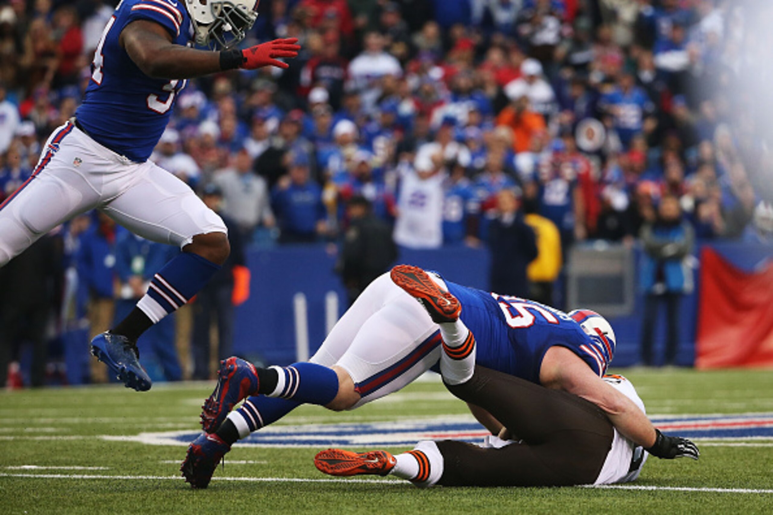 ORCHARD PARK, NY - NOVEMBER 30:   Brian Hoyer #6 of the Cleveland Browns is sacked by Jerry Hughes #55 of the Buffalo Bills during the second half at Ralph Wilson Stadium on November 30, 2014 in Orchard Park, New York.  (Photo by Tom Szczerbowski/Getty Im