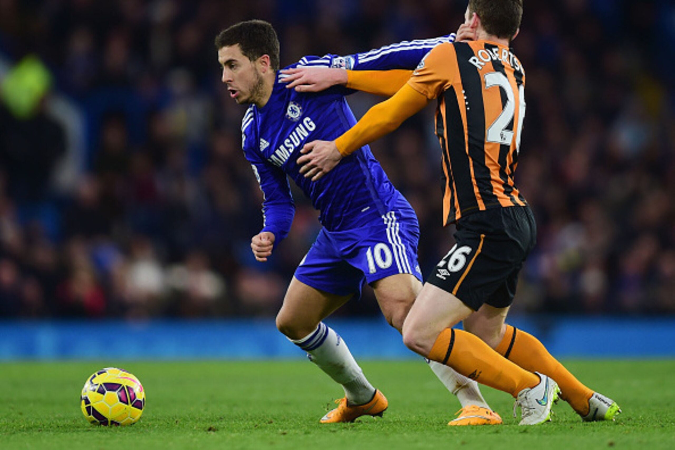LONDON, ENGLAND - DECEMBER 13:  Eden Hazard of Chelsea holds off Andrew Robertson of Hull City during the Barclays Premier League match between Chelsea and Hull City at Stamford Bridge on December 13, 2014 in London, England.  (Photo by Jamie McDonald/Get