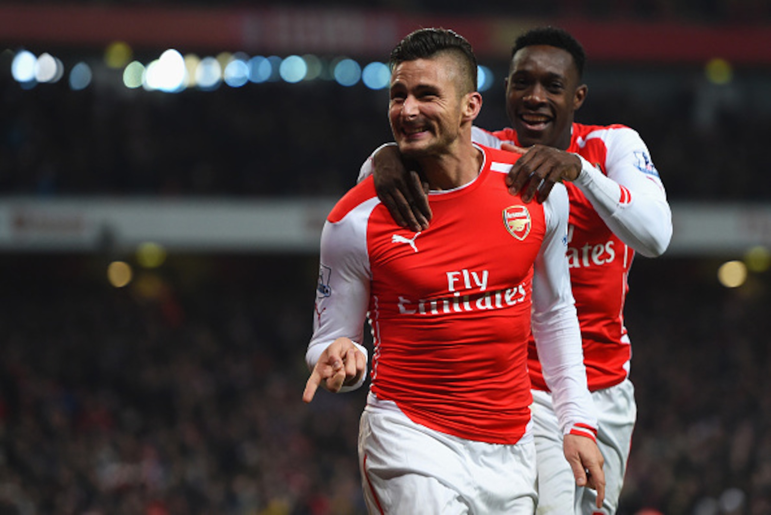 LONDON, ENGLAND - DECEMBER 13:  Olivier Giroud of Arsenal celebrates scoring his team's third goal with Danny Welbeck during the Barclays Premier League match between Arsenal and Newcastle United at Emirates Stadium on December 13, 2014 in London, England