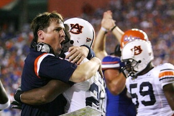 GAINESVILLE, FL - SEPTEMBER 29:  Defensive coordinator Will Muschamp of the Auburn Tigers jumps into the arms of defensive back Patrick Lee #20 after Lee helped cause a fumble late in the first half against the Florida Gators at Ben Hill Griffin Stadium S