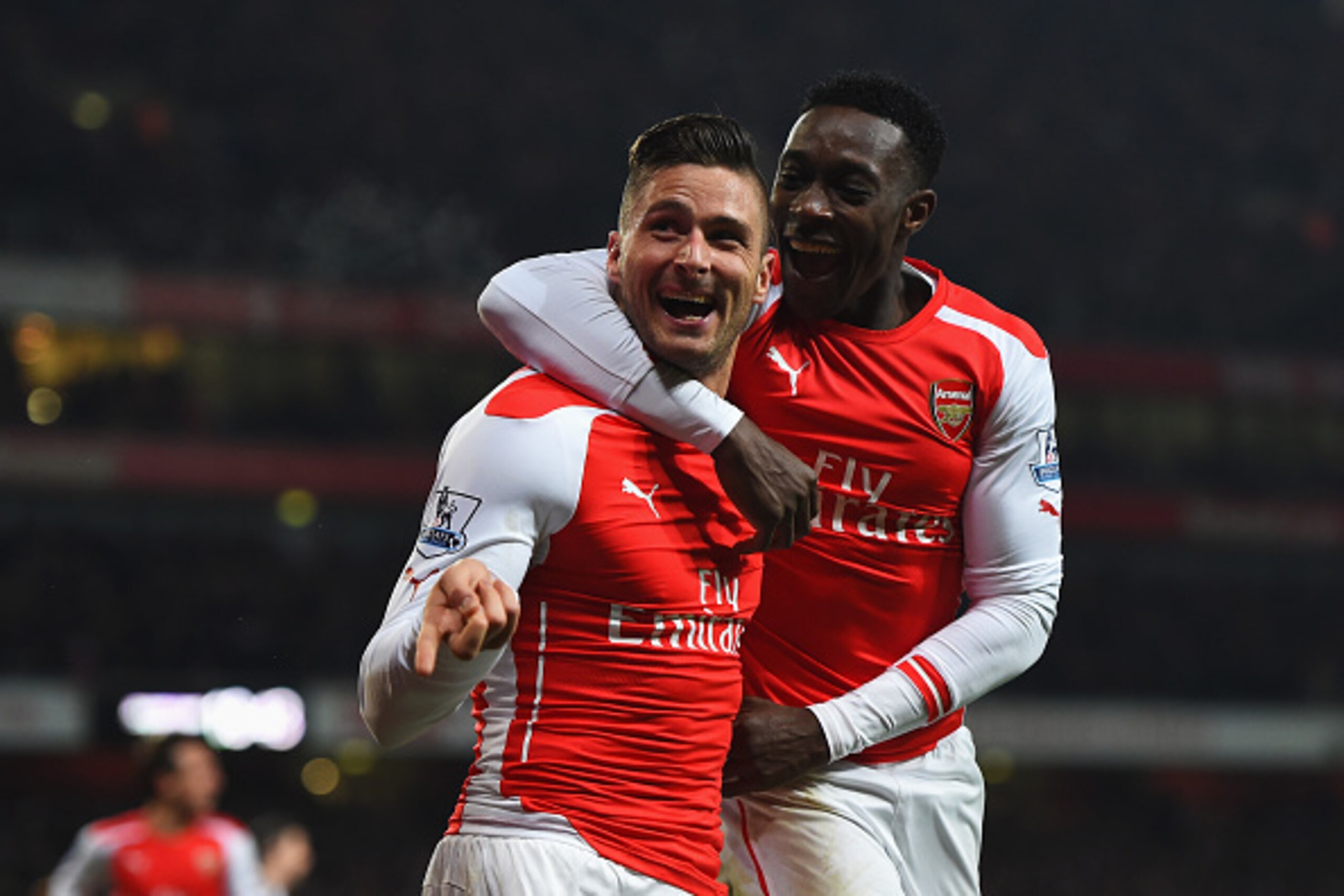 LONDON, ENGLAND - DECEMBER 13:  Olivier Giroud of Arsenal celebrates scoring his team's third goal with Danny Welbeck during the Barclays Premier League match between Arsenal and Newcastle United at Emirates Stadium on December 13, 2014 in London, England