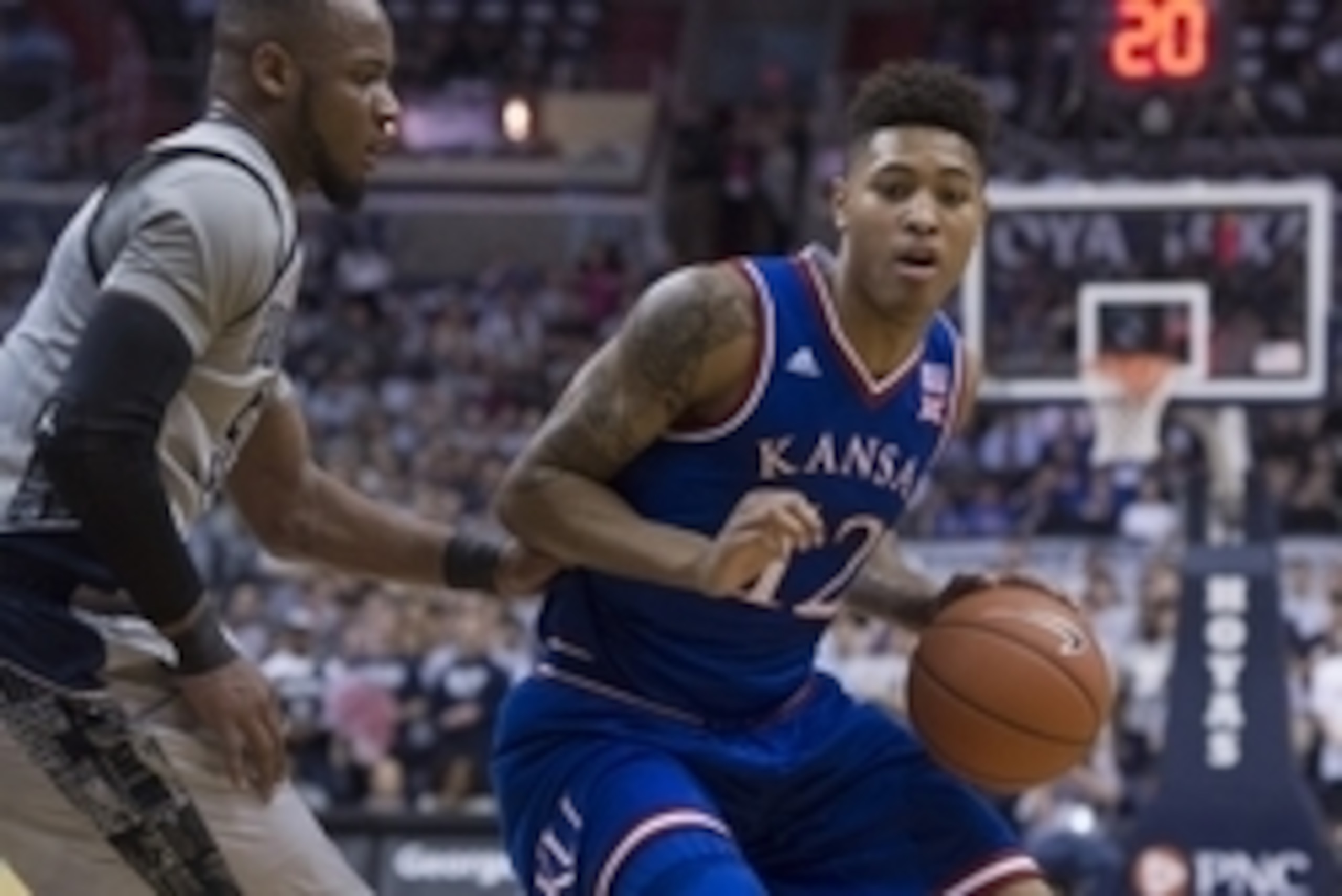 Dec 10, 2014; Washington, DC, USA; Kansas Jayhawks guard Kelly Oubre Jr. (12) drives on Georgetown Hoyas guard Jabril Trawick (55) during the first half at Verizon Center. Mandatory Credit: Tommy Gilligan-USA TODAY Sports