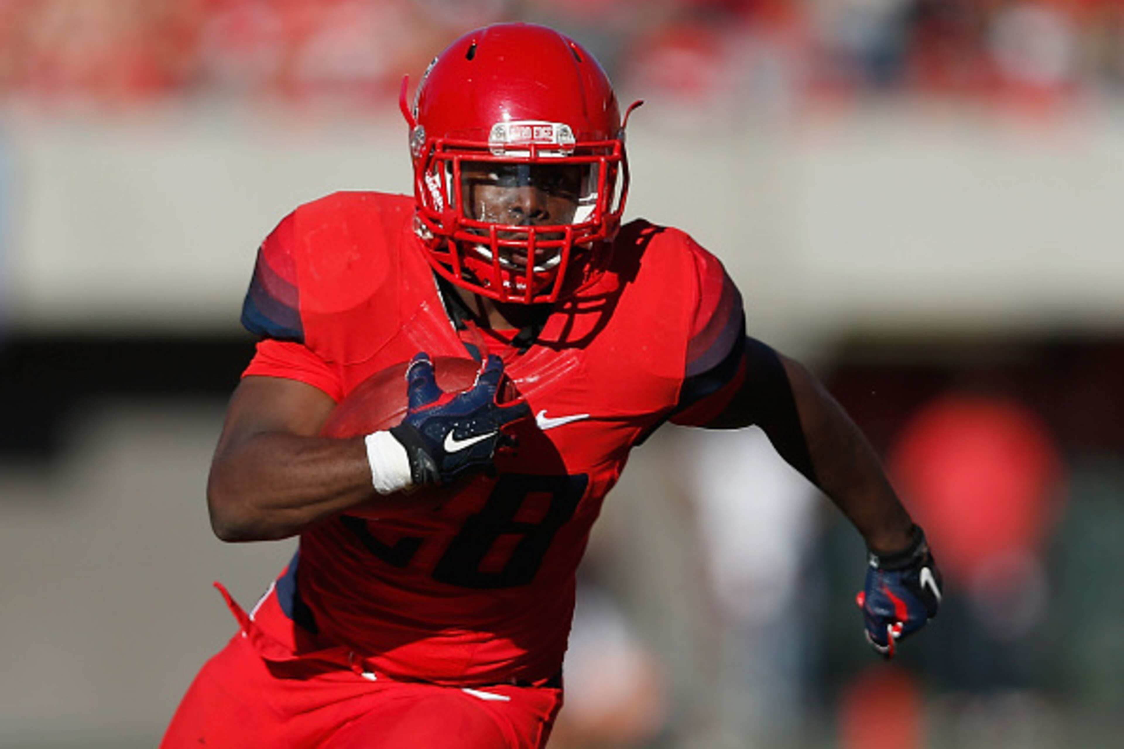 TUCSON, AZ - NOVEMBER 28:  Running back Nick Wilson #28 of the Arizona Wildcats rushes the football for a 21-yard touchdown in the second quarter against the Arizona State Sun Devils during the Territorial Cup college football game at Arizona Stadium on N