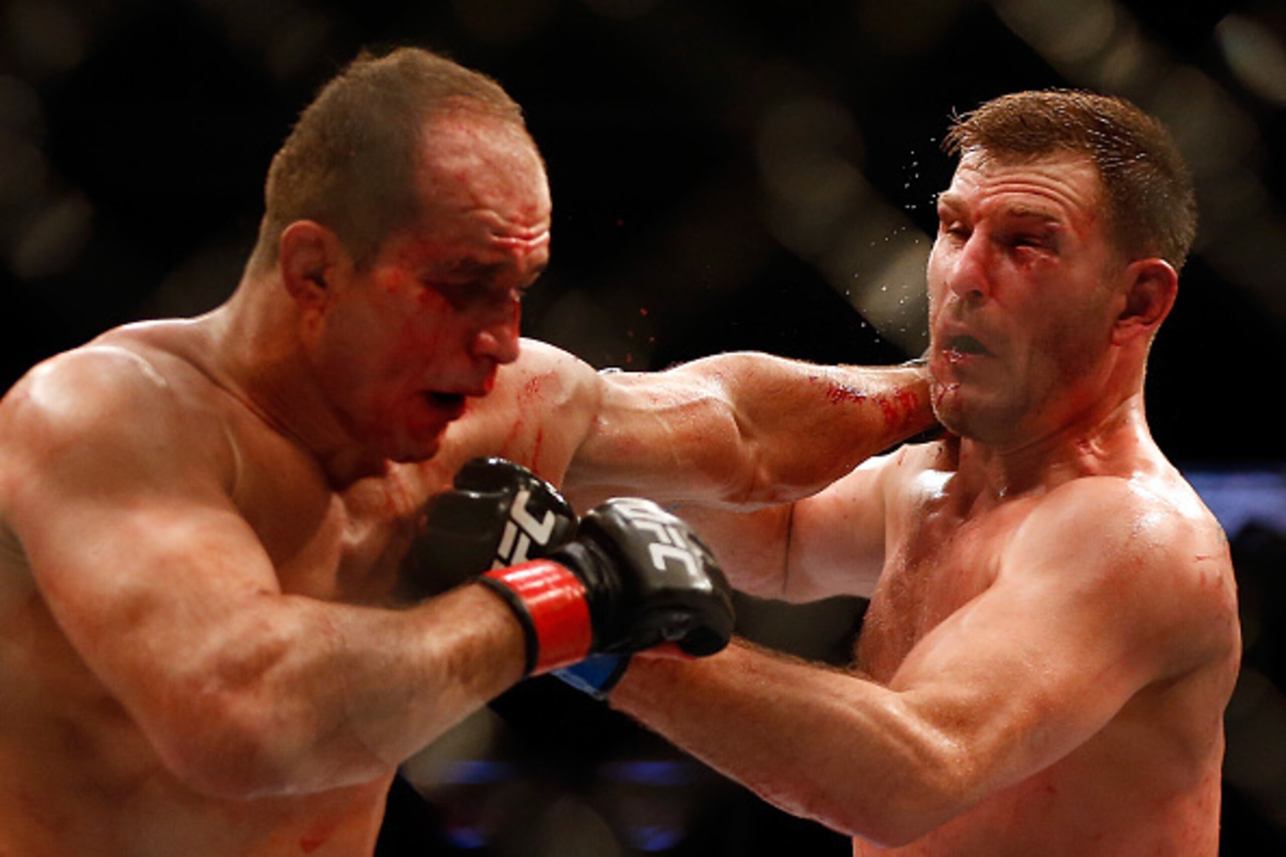 PHOENIX, AZ - DECEMBER 13:  (L-R) Junior dos Santos and Stipe Miocic exchange punches in their heavyweight bout during the UFC Fight Night event at the at U.S. Airways Center on December 13, 2014 in Phoenix, Arizona.  (Photo by Christian Petersen/Getty Im