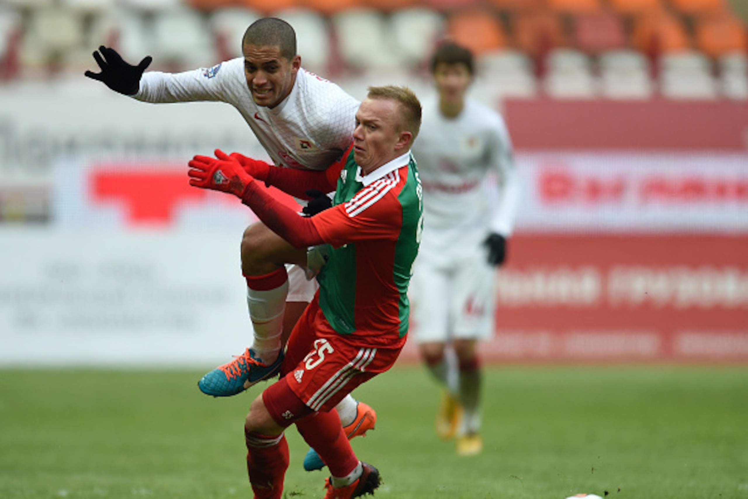 MOSCOW, RUSSIA - NOVEMBER 30: Renat Yanbayev (R) of FC Lokomotiv Moscow challenged by Romulo of FC Spartak Moscow during the Russian Premier League match between FC Lokomotiv Moscow and FC Spartak Moscow at Lokomotiv Stadium on November 30, 2014 in Moscow