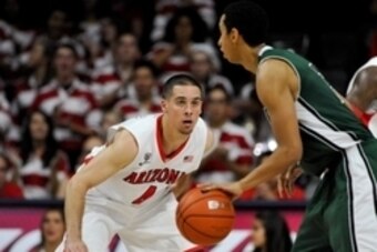 Dec 9, 2014; Tucson, AZ, USA; Arizona Wildcats guard T.J. McConnell (4) defends Utah Valley Wolverines guard Marcel Davis (2) during the second half at McKale Center. Arizona won 87-56. Mandatory Credit: Casey Sapio-USA TODAY Sports