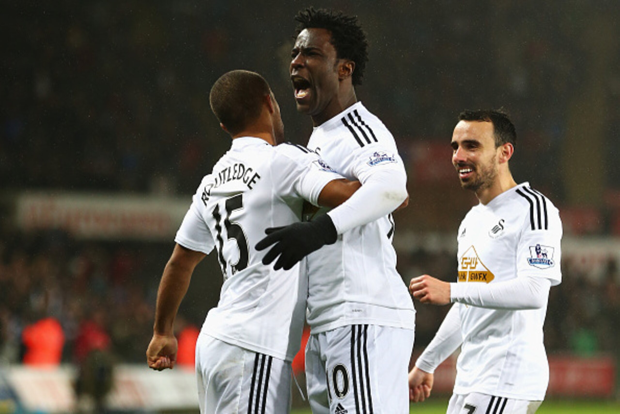 SWANSEA, WALES - DECEMBER 14: Wilfried Bony (C) of Swansea City celebrates his goal with Wayne Routledge (L) and Leon Britton during the Barclays Premier League match between Swansea City and Tottenham Hotspur at Liberty Stadium on December 14, 2014 in S SWANSEA, WALES - DECEMBER 14: Wilfried Bony (C) of Swansea City celebrates his goal with Wayne Routledge (L) and Leon Britton during the Barclays Premier League match between Swansea City and Tottenham Hotspur at Liberty Stadium on December 14, 2014 in S