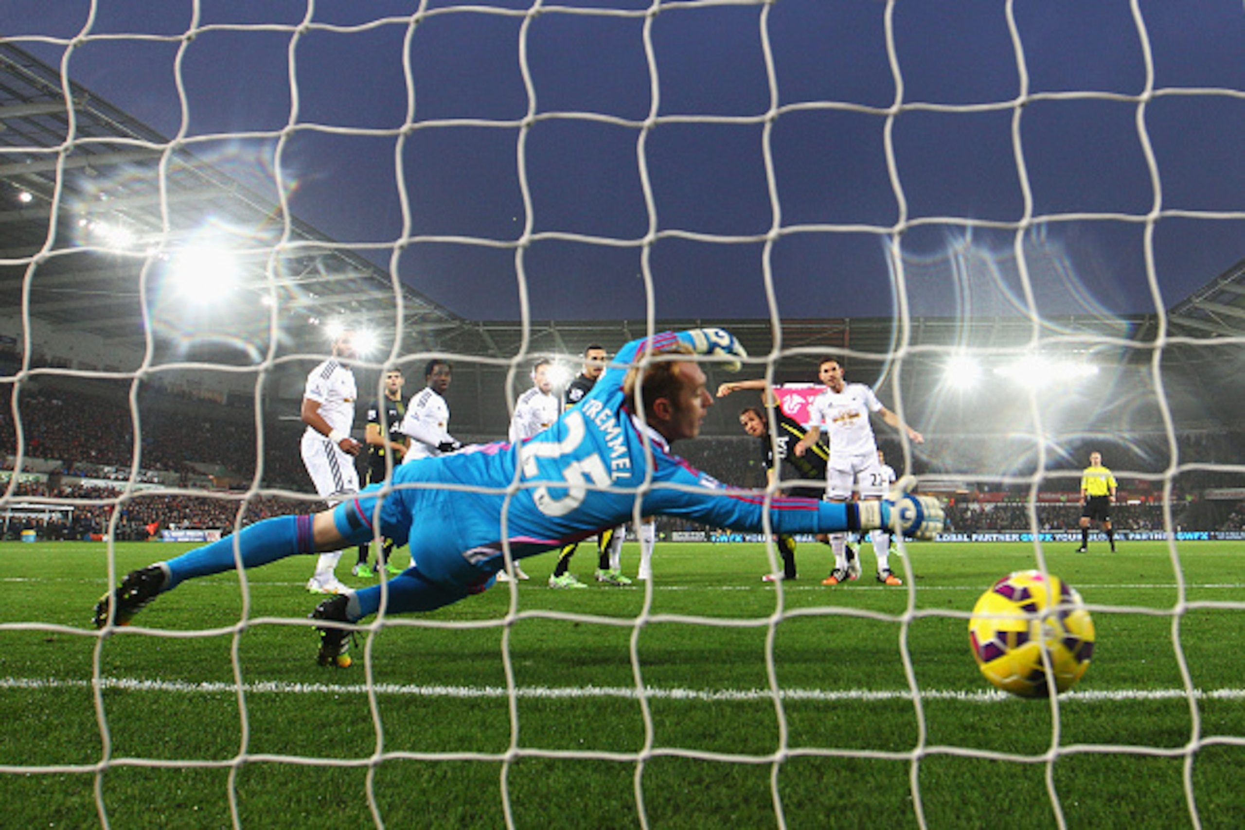 SWANSEA, WALES - DECEMBER 14: Harry Kane of Tottenham Hotspur heads the opening goal past Gerhard Tremmel of Swansea City during the Barclays Premier League match between Swansea City and Tottenham Hotspur at Liberty Stadium on December 14, 2014 in Swans SWANSEA, WALES - DECEMBER 14: Harry Kane of Tottenham Hotspur heads the opening goal past Gerhard Tremmel of Swansea City during the Barclays Premier League match between Swansea City and Tottenham Hotspur at Liberty Stadium on December 14, 2014 in Swans
