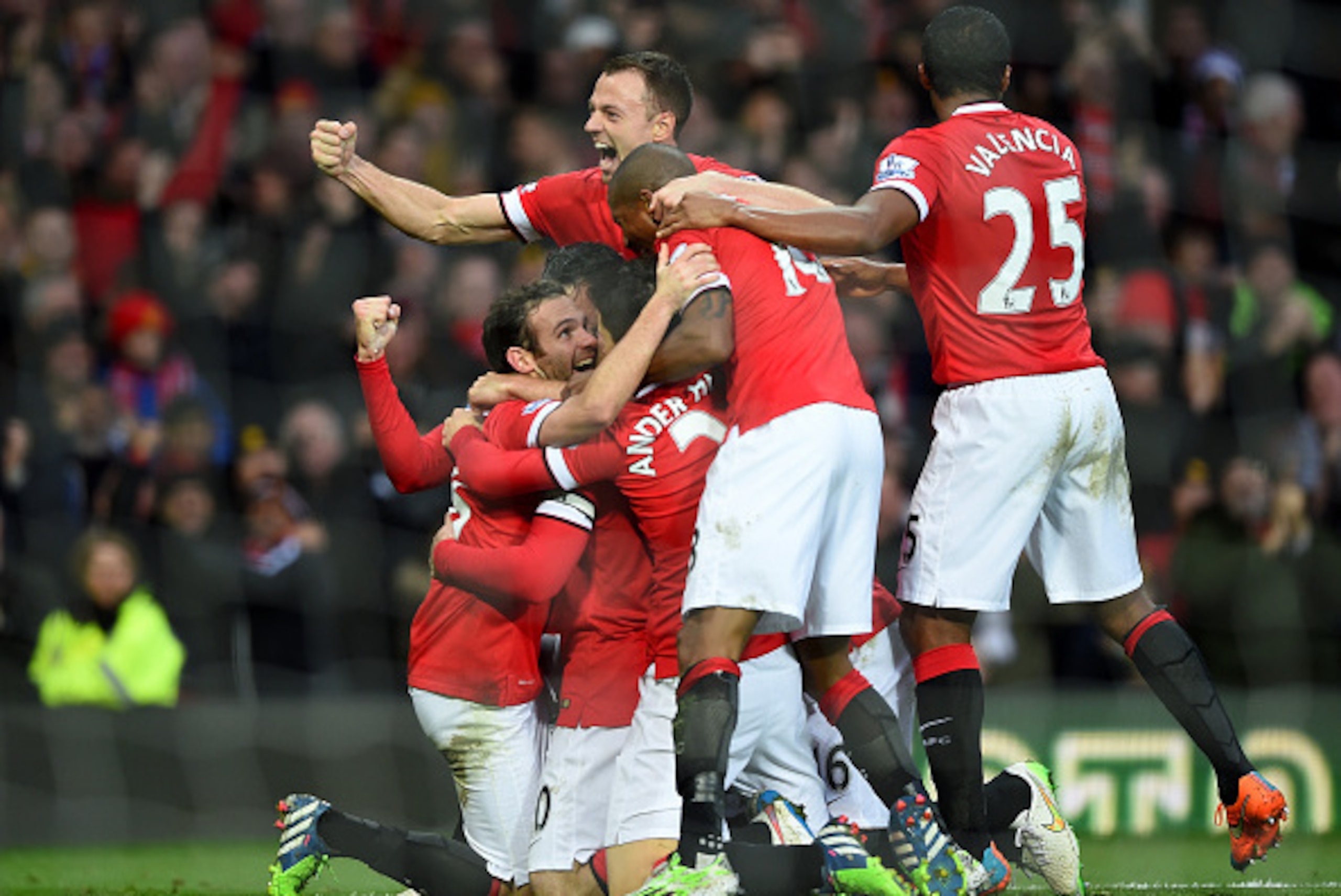 MANCHESTER, ENGLAND - DECEMBER 14:  Robin van Persie of Manchester United celebrates scoring the third goal with his team-mates during the Barclays Premier League match between Manchester United and Liverpool at Old Trafford on December 14, 2014 in Manche