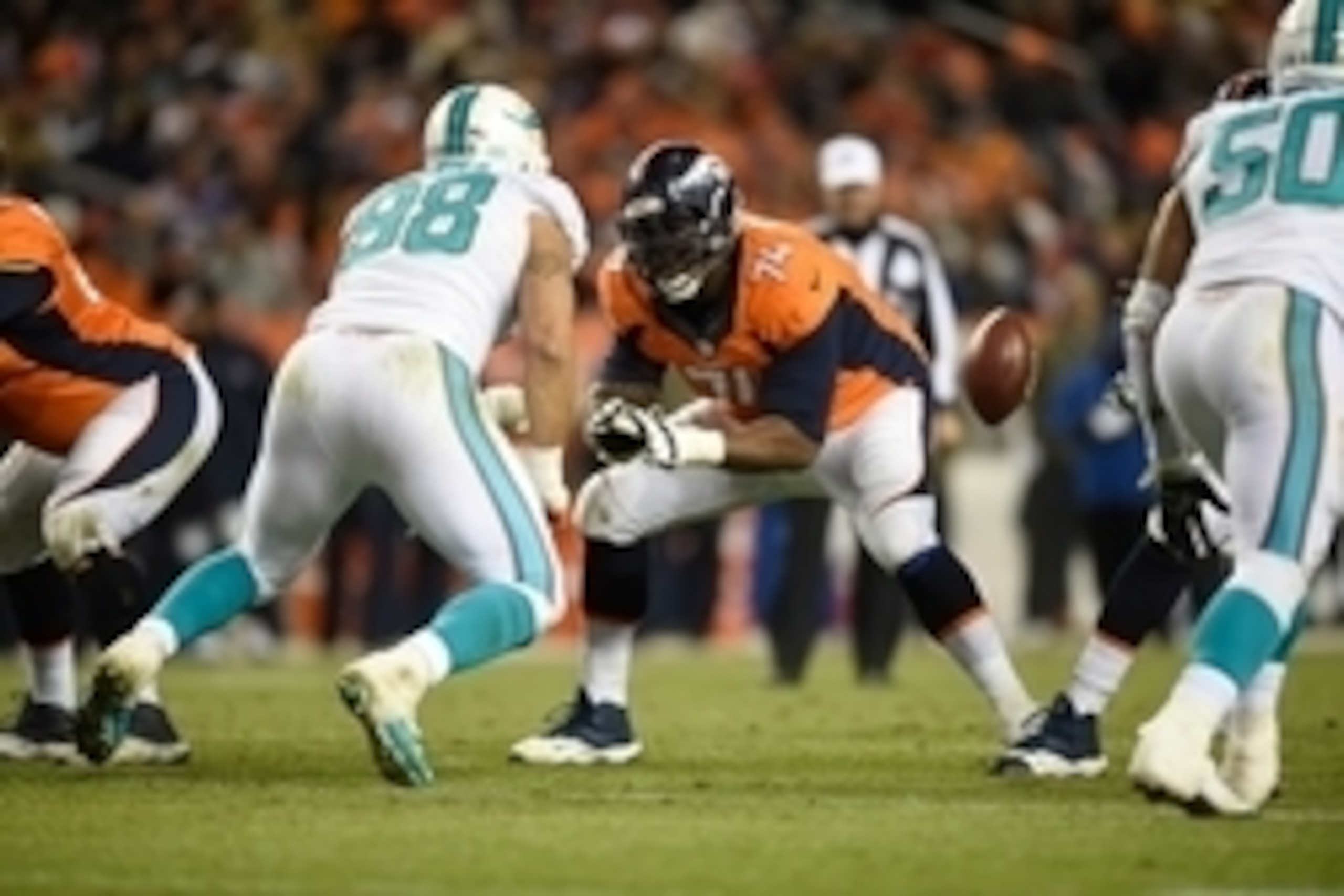 Nov 23, 2014; Denver, CO, USA; Denver Broncos guard Orlando Franklin (74) pass protects on Miami Dolphins defensive tackle Jared Odrick (98) in the third quarter at Sports Authority Field at Mile High. Mandatory Credit: Ron Chenoy-USA TODAY Sports