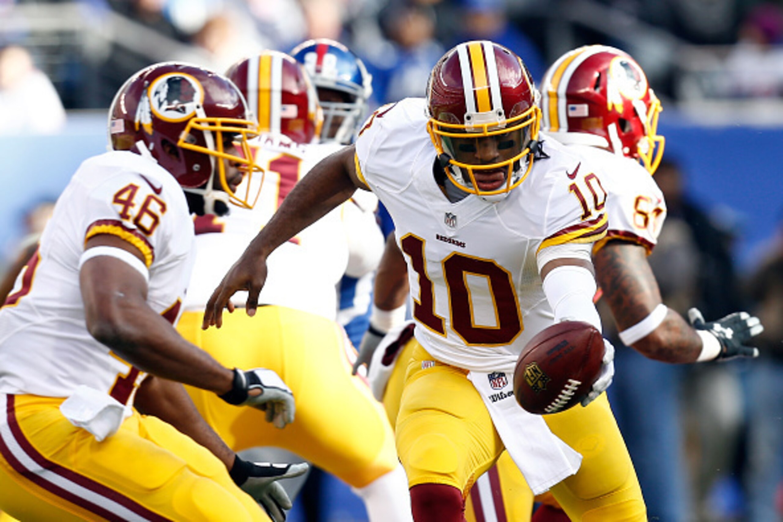 EAST RUTHERFORD, NJ - DECEMBER 14:  Robert Griffin III #10 of the Washington Redskins hands the ball off to Alfred Morris #46 against the New York Giants during their game at MetLife Stadium on December 14, 2014 in East Rutherford, New Jersey.  (Photo by 