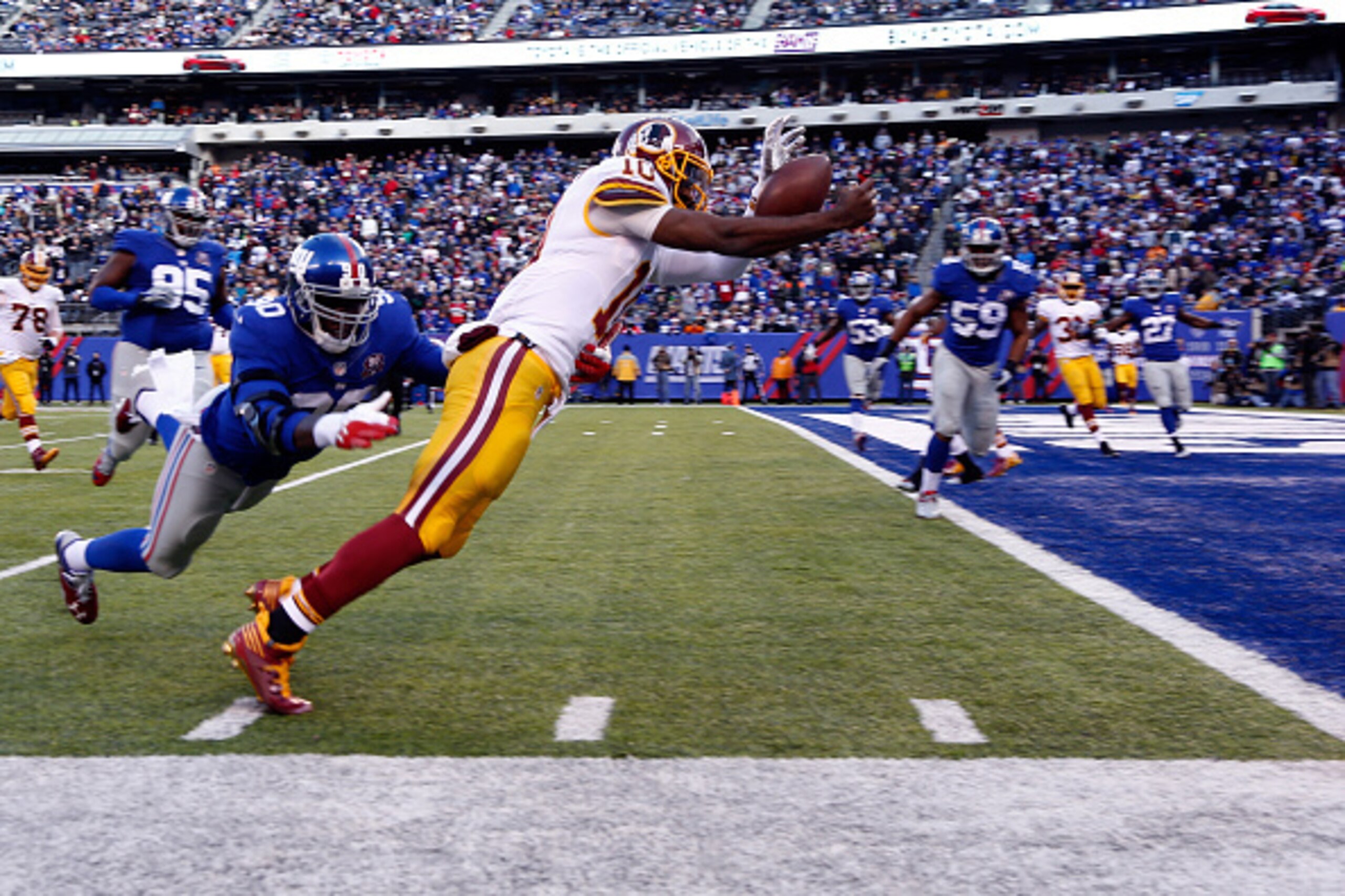 EAST RUTHERFORD, NJ - DECEMBER 14:  Robert Griffin III #10 of the Washington Redskins fumbles the ball out of bounds in End Zone in the second quarter against the New York Giants during their game at MetLife Stadium on December 14, 2014 in East Rutherford