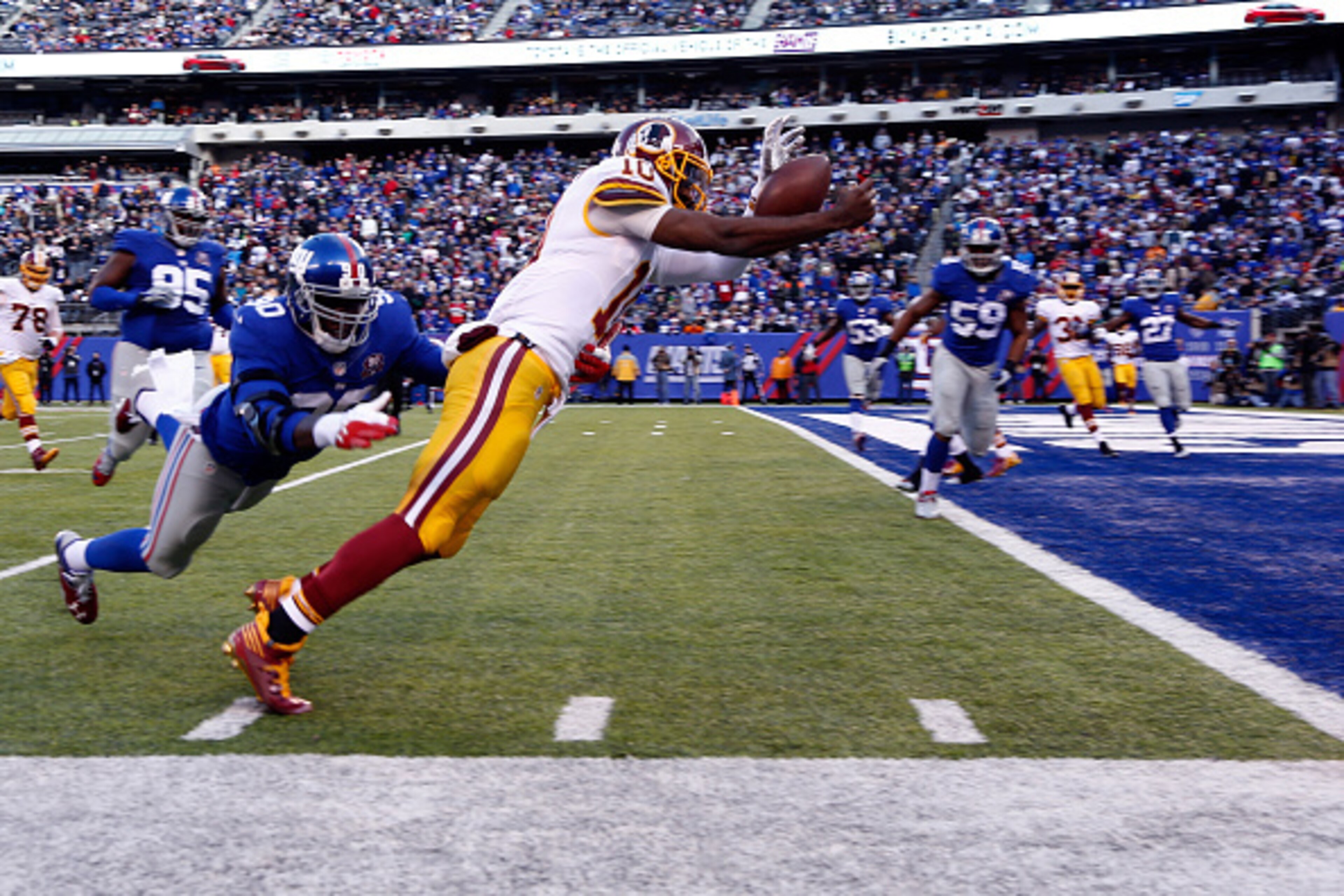 EAST RUTHERFORD, NJ - DECEMBER 14:  Robert Griffin III #10 of the Washington Redskins fumbles the ball out of bounds in End Zone in the second quarter against the New York Giants during their game at MetLife Stadium on December 14, 2014 in East Rutherford
