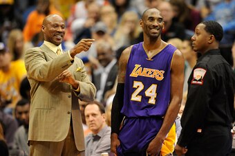 MINNEAPOLIS, MN - DECEMBER 14: Byron Scott of the Los Angeles Lakers speaks with Kobe Bryant #24 during a time out in the fourth quarter of the game against the Minnesota Timberwolves on December 14, 2014 at Target Center in Minneapolis, Minnesota. The La