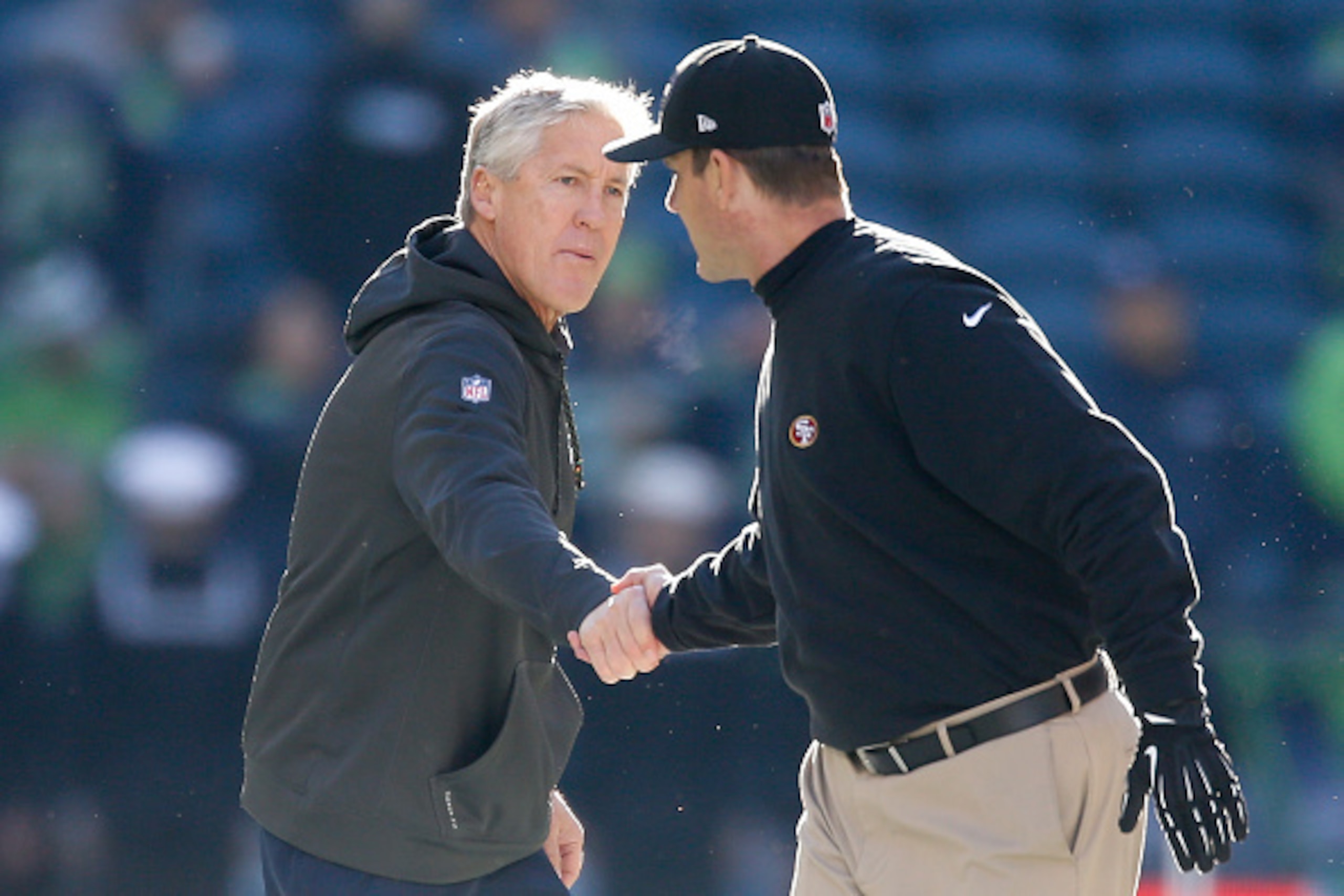 SEATTLE, WA - DECEMBER 14:  Head coach Pete Carroll (L) of the Seattle Seahawks shakes hands with head coach Jim Harbaugh (R) of the San Francisco 49ers prior to the game at CenturyLink Field on December 14, 2014 in Seattle, Washington.  (Photo by Otto Gr