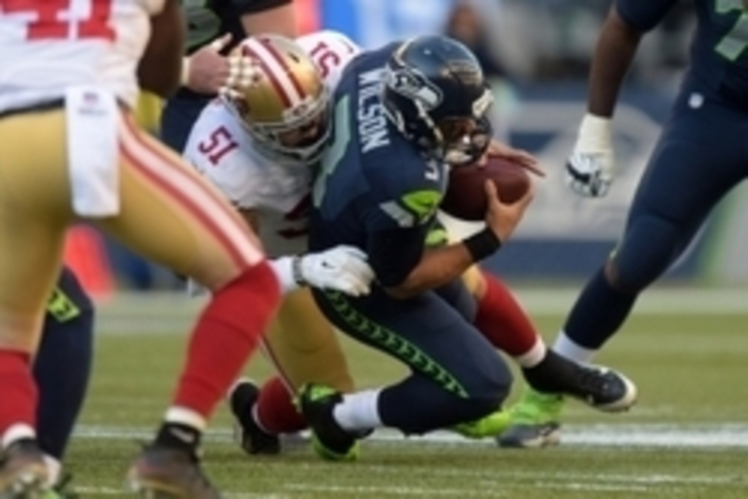 Dec 14, 2014; Seattle, WA, USA; San Francisco 49ers linebacker Dan Skuta (51) sacks Seattle Seahawks quarterback Russell Wilson (3) in the second quarter at CenturyLink Field. Mandatory Credit: Kirby Lee-USA TODAY Sports