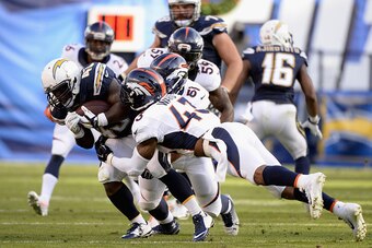 SAN DIEGO, CA - DECEMBER 14:  Running back Branden Oliver #43 of the San Diego Chargers is tackled by strong safety T.J. Ward #43 of the Denver Broncos  at Qualcomm Stadium on December 14, 2014 in San Diego, California.  (Photo by Harry How/Getty Images)