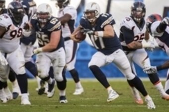 Dec 14, 2014; San Diego, CA, USA; San Diego Chargers quarterback Philip Rivers (17) is chased out of the pocket by Denver Broncos defensive end Derek Wolfe (95) during third quarter action at Qualcomm Stadium. Mandatory Credit: Robert Hanashiro-USA TODAY 