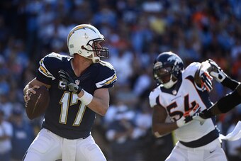 SAN DIEGO, CA - DECEMBER 14:  Quarterback Philip Rivers #17 of the San Diego Chargers looks to pass while pressured by outside linebacker Brandon Marshall #54 of the Denver Broncos at Qualcomm Stadium on December 14, 2014 in San Diego, California.  (Photo