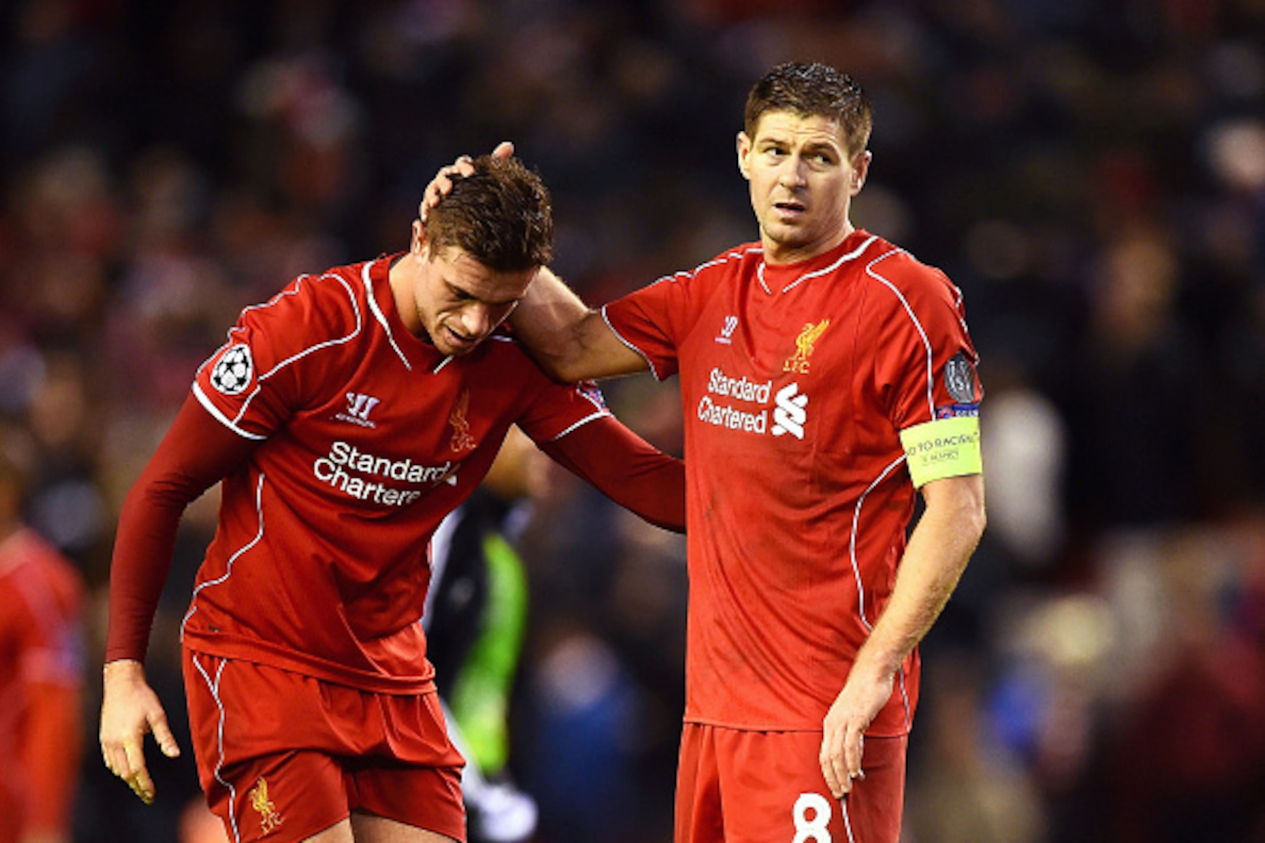 LIVERPOOL, ENGLAND - DECEMBER 09:  (L-R) Dejected Liverpool players Jordan Henderson and Steven Gerrard react following their team's 1-1 draw and exit from the competition during the UEFA Champions League group B match between Liverpool and FC Basel 1893 