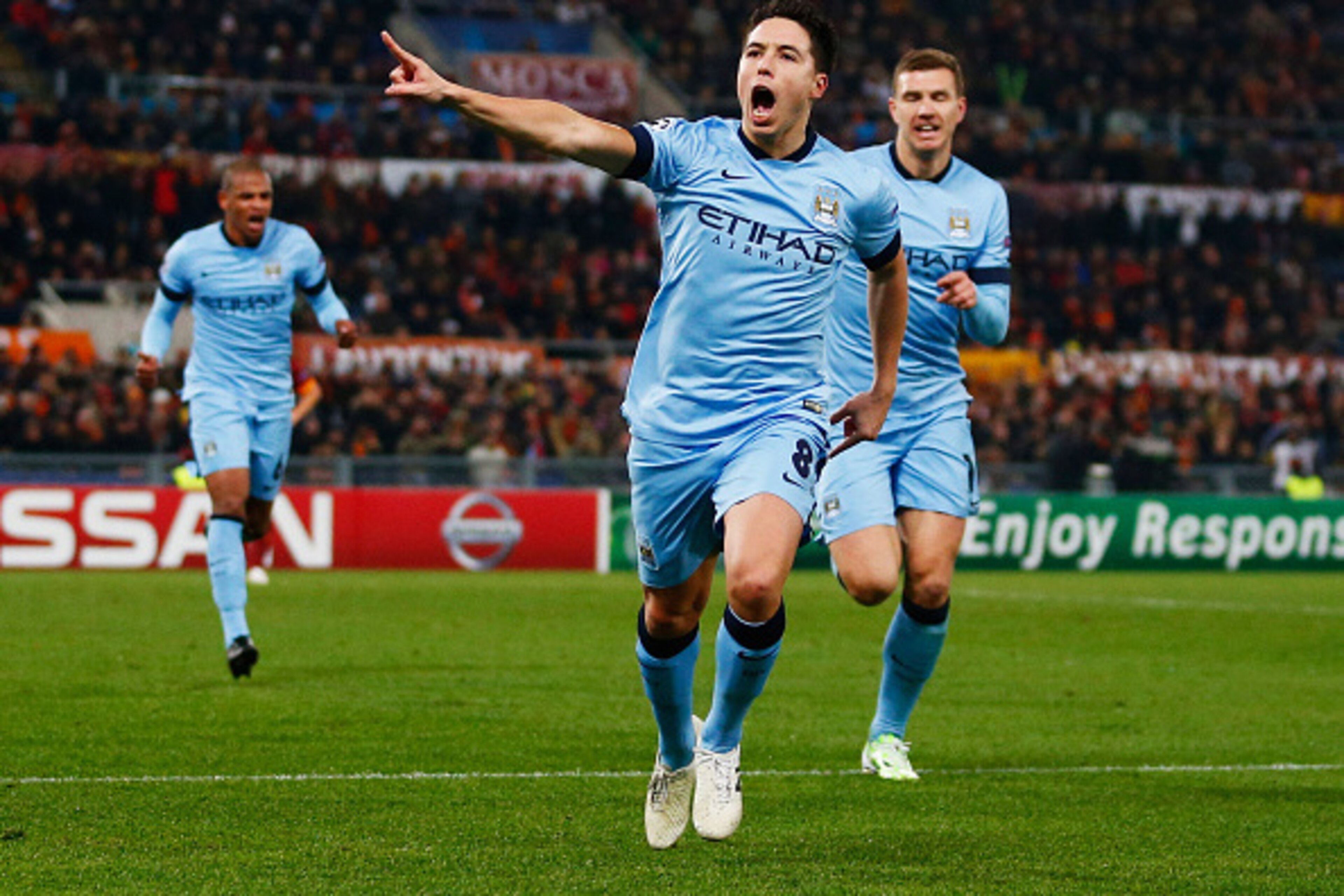 ROME, ITALY - DECEMBER 10:  Samir Nasri of Manchester City (8) celebrates with Edin Dzeko as he scores their first goal during the UEFA Champions League Group E match between AS Roma and Manchester City FC at Stadio Olimpico on December 10, 2014 in Rome, 