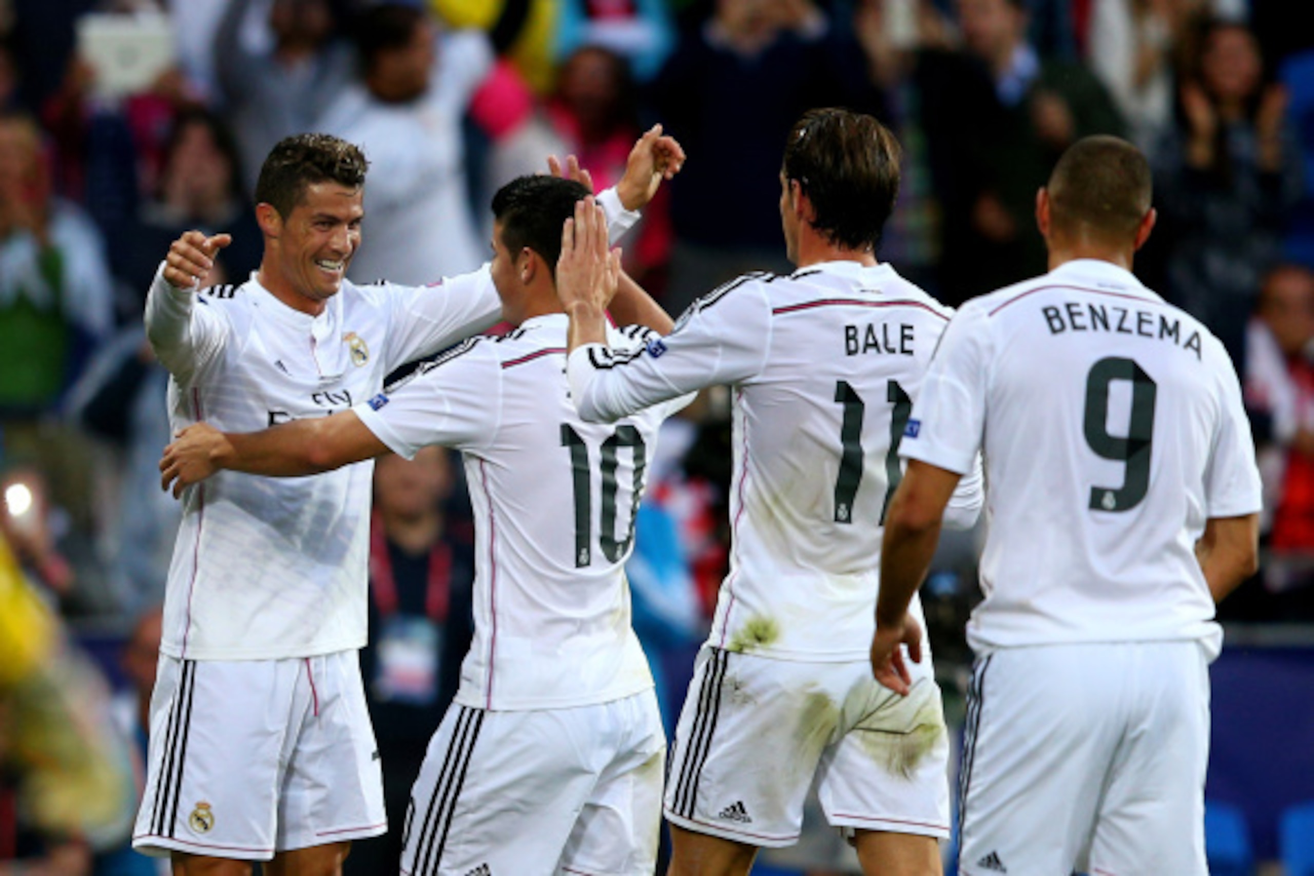 CARDIFF, WALES - AUGUST 12: (L-R) Cristiano Ronaldo of Real Madrid celebrates with teammates James Rodriguez, Gareth Bale and Karim Benzema after scoring the opening goal during the UEFA Super Cup between Real Madrid and Sevilla FC at Cardiff City Stadiu CARDIFF, WALES - AUGUST 12: (L-R) Cristiano Ronaldo of Real Madrid celebrates with teammates James Rodriguez, Gareth Bale and Karim Benzema after scoring the opening goal during the UEFA Super Cup between Real Madrid and Sevilla FC at Cardiff City Stadiu